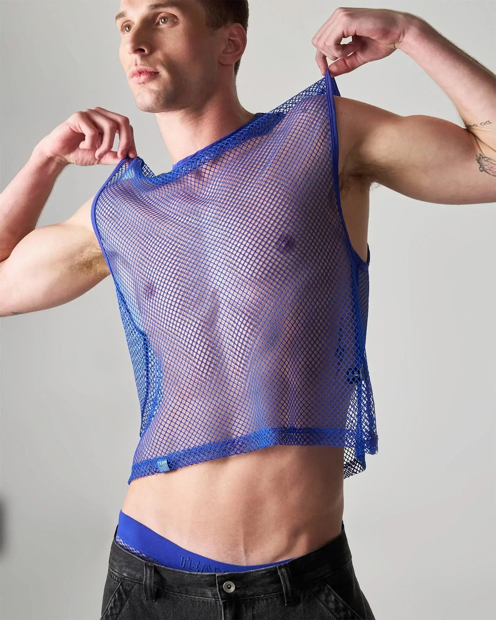 Edge net mesh muscle tank in blue sheer translucent fabric with reinforced trim along neckline and hem