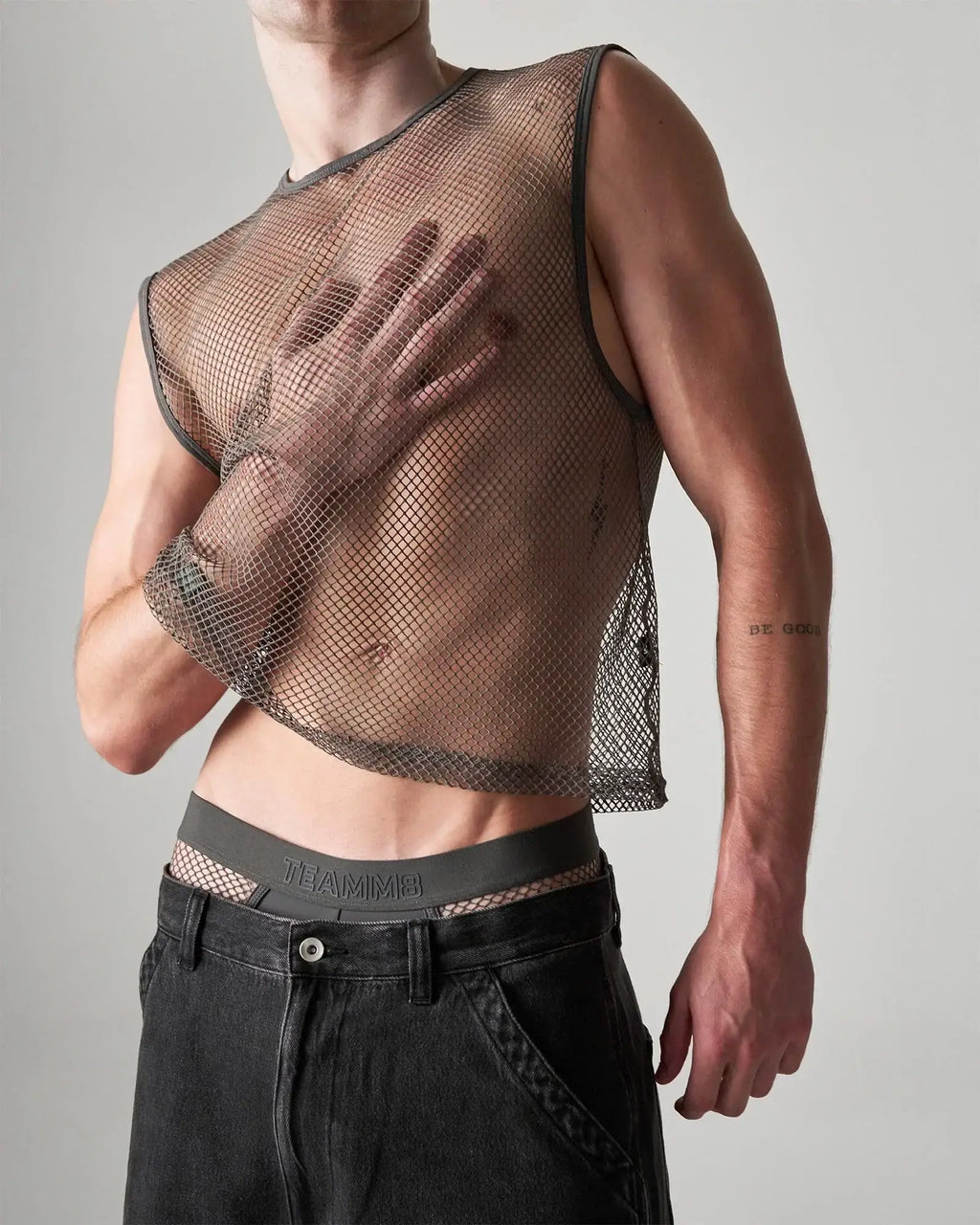 Dark gray mesh muscle tank top with fitted cropped design and reinforced shoulder seams edge net mesh muscle tank