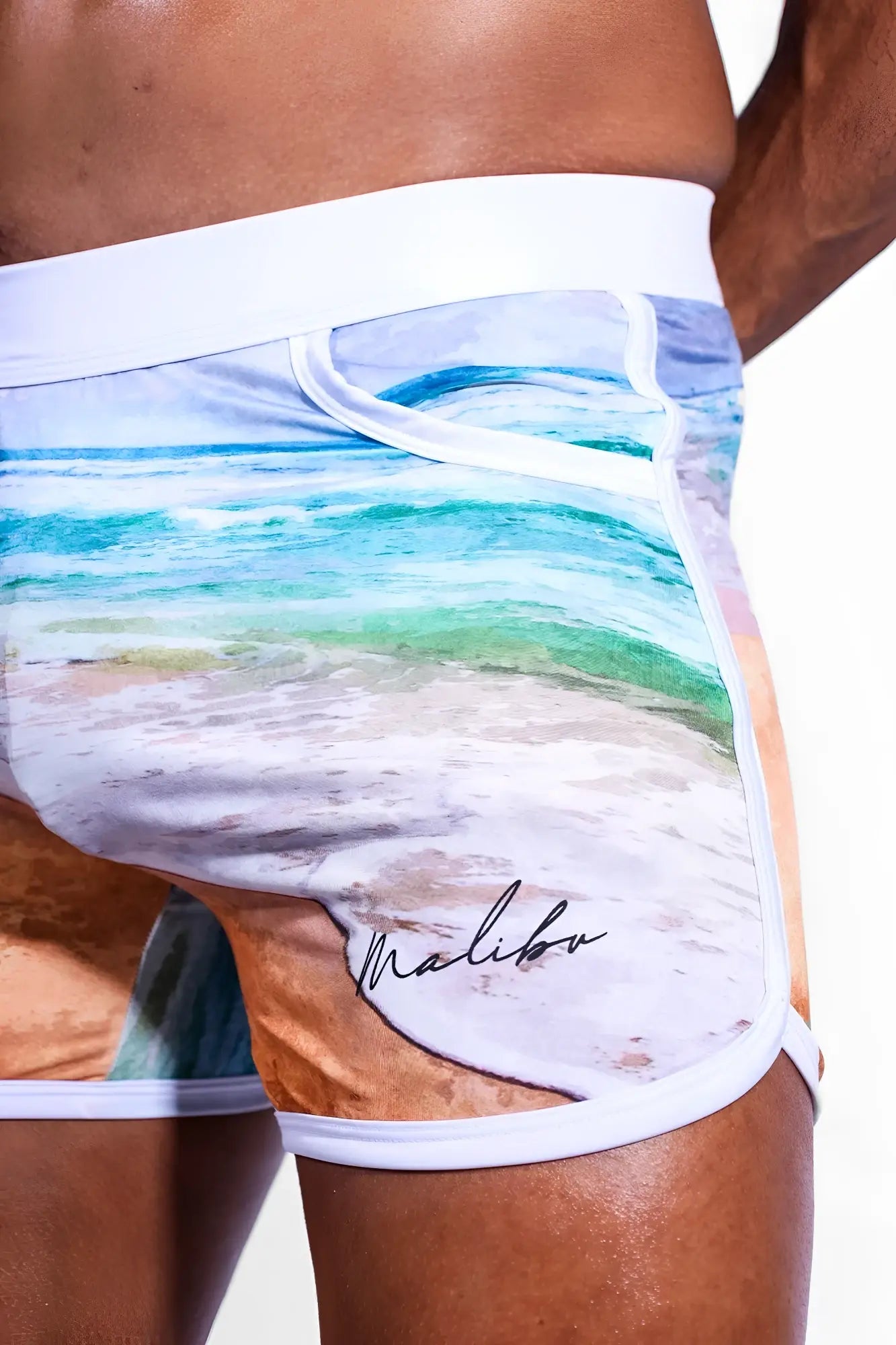Elevate Comfort 4 inch white athletic shorts with vibrant turquoise beach scene and malibu logo for casual wear