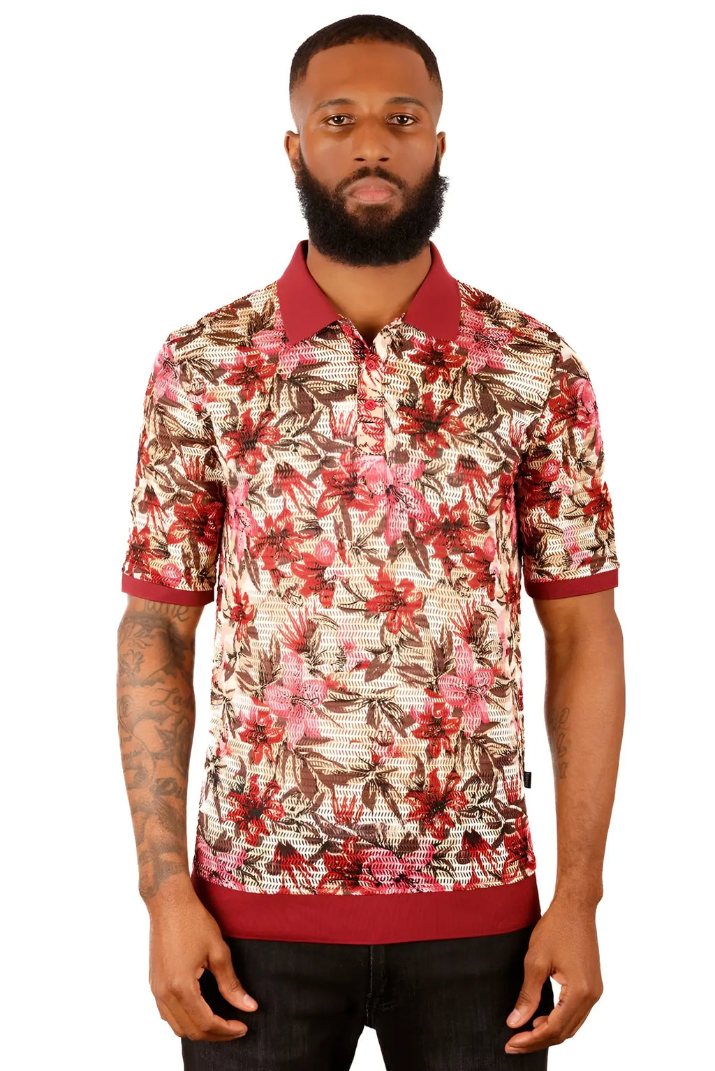 A man wearing an entwine form polo shirt with red and brown floral pattern and maroon collar on beige background