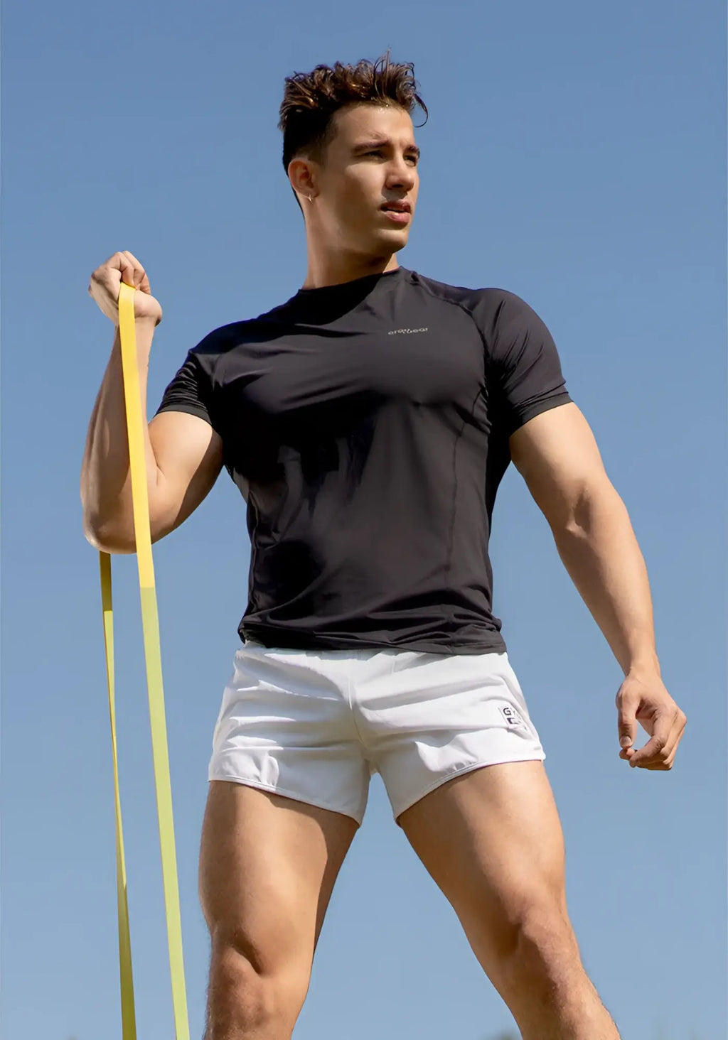 Black athletic t-shirt with short sleeves and subtle logo paired with ergowear built in x4d bikini mesh gym shorts white size m