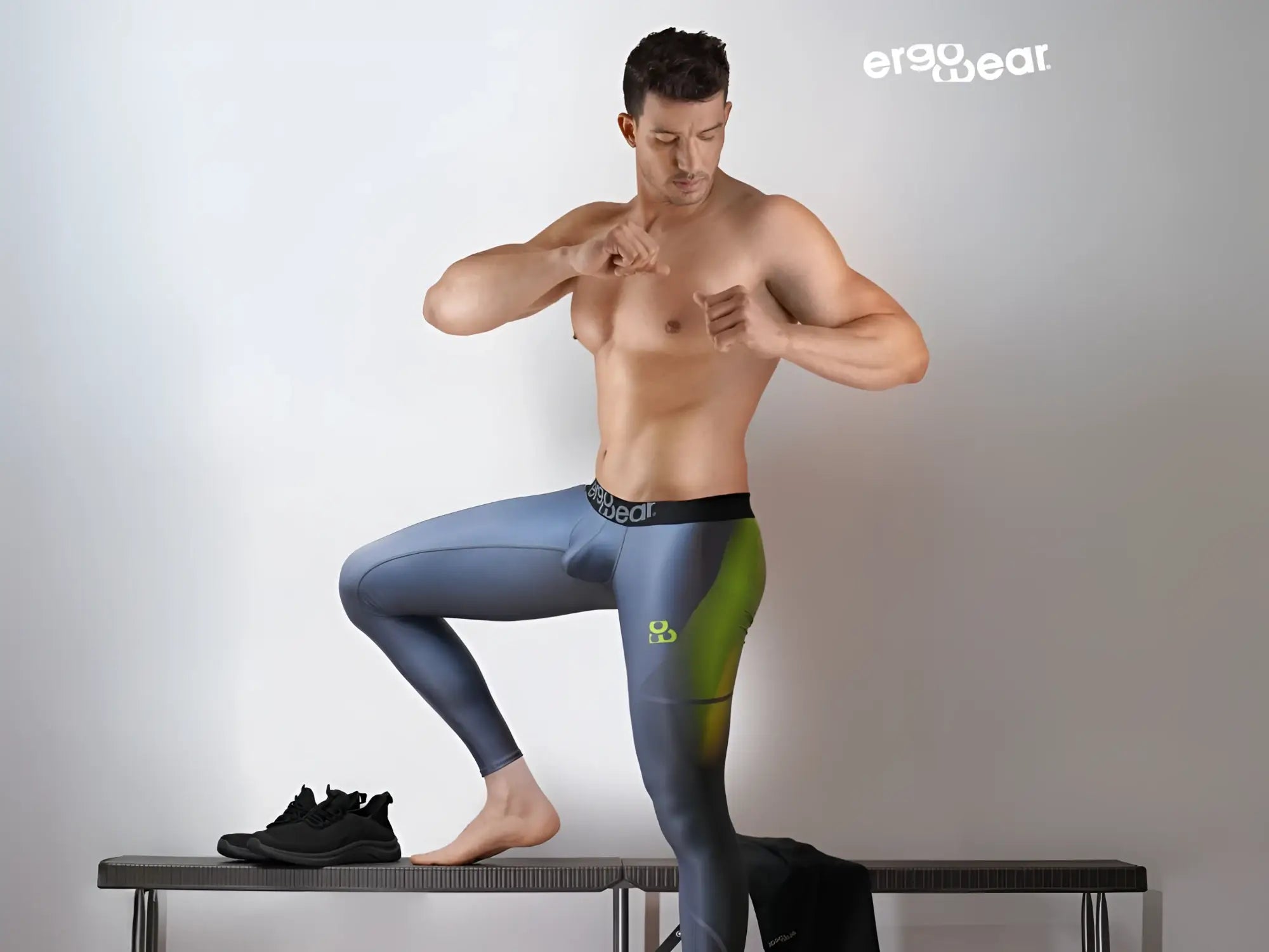 A pair of ergo wear ew1604 max se men’s ergonomic leggings in gradient blue and green with logo waistband