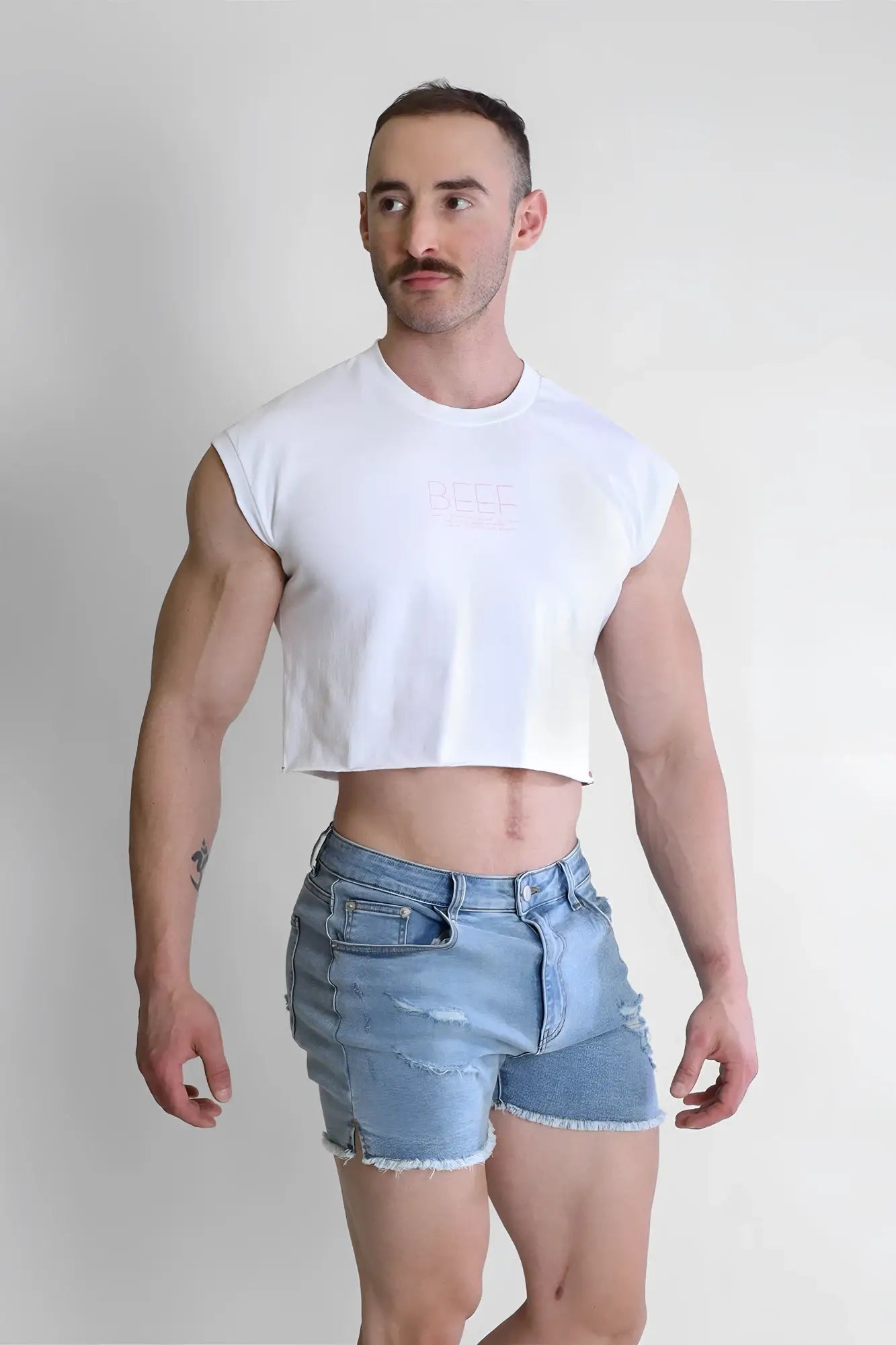 White sleeveless escapism muscle-fit crop tank with subtle faded logo on chest designed for casual wear