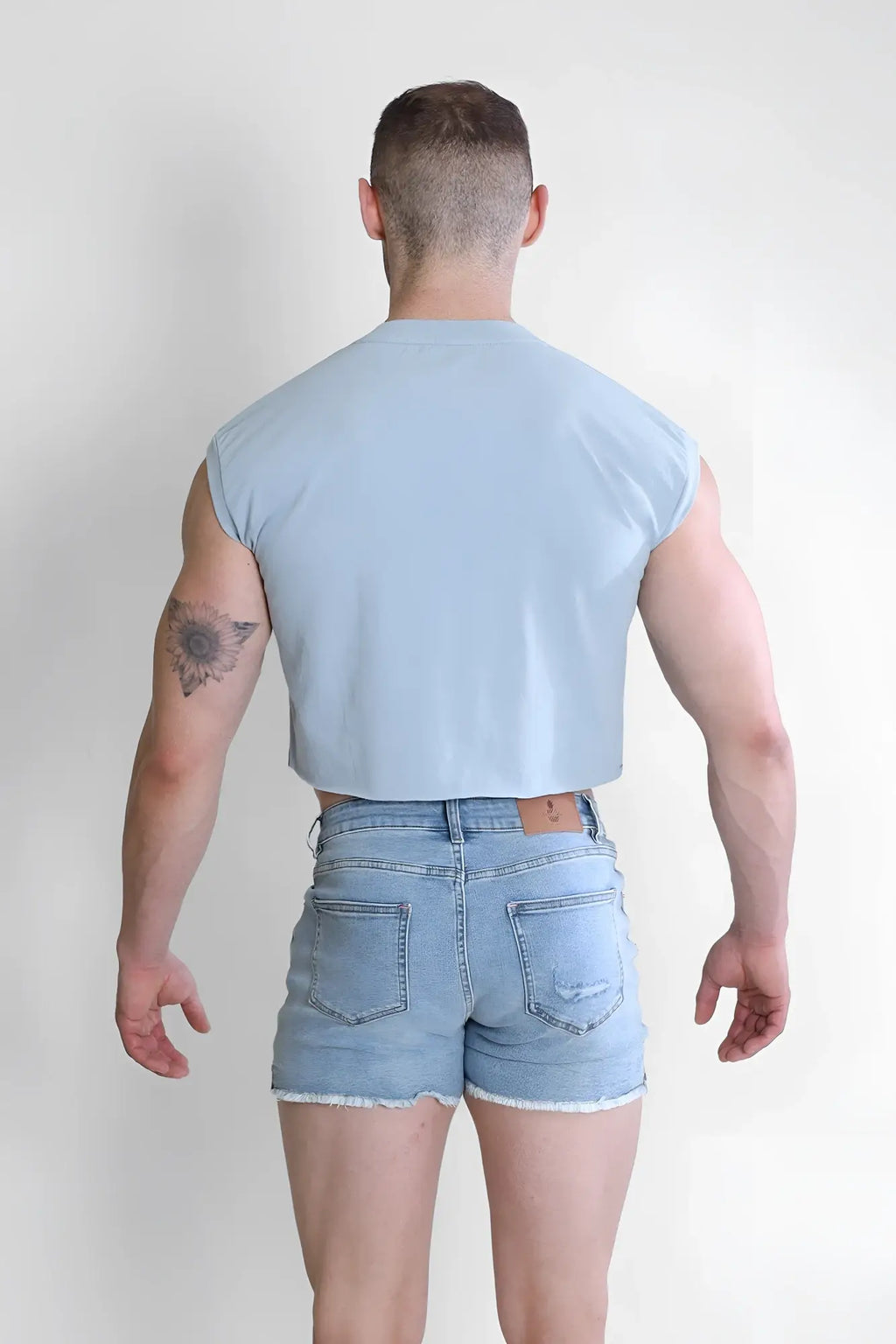 Light blue sleeveless muscle-fit cropped tank top made from breathable fabric for casual and active wear
