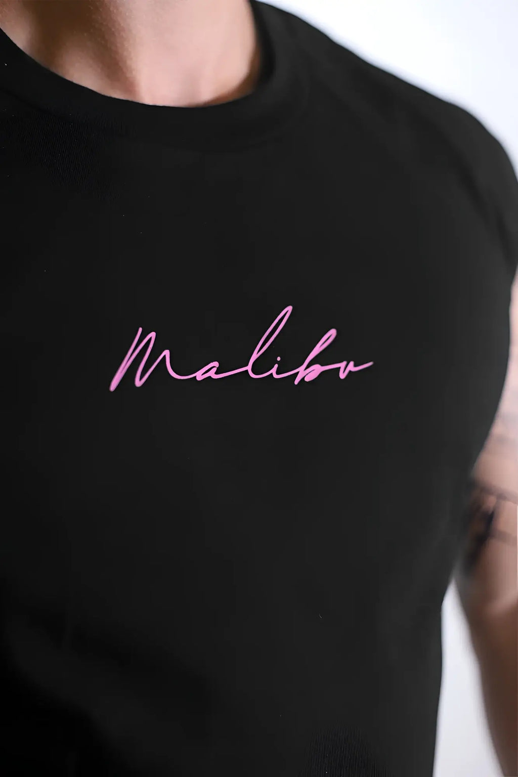 Black sleeveless muscle-fit crop tank with pink malibu embroidery perfect for casual summer wear