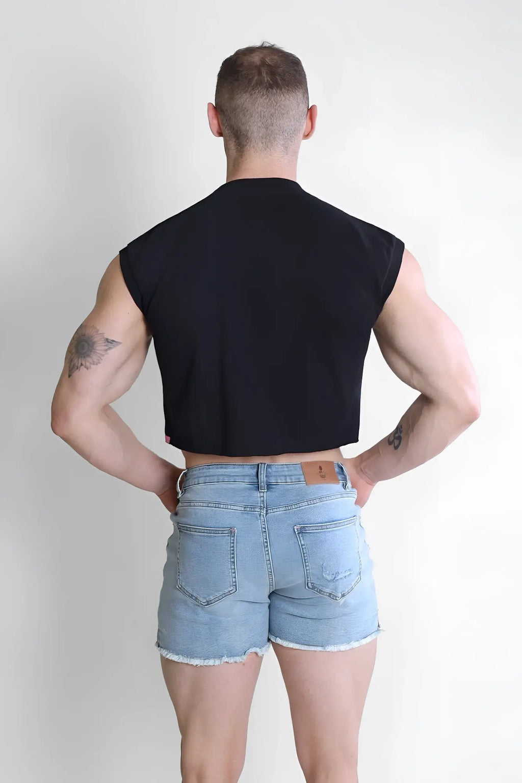 Black sleeveless muscle-fit crop tank top with fitted athletic cut from escapism by puta