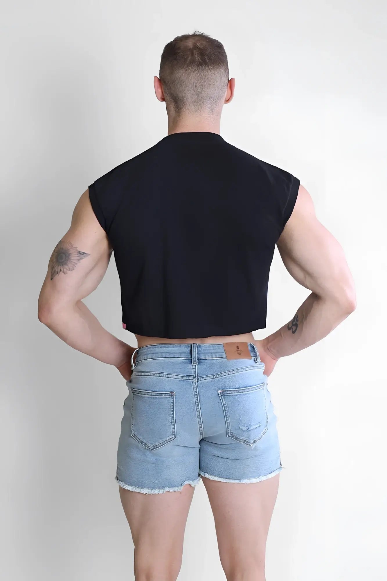 Black sleeveless muscle-fit crop tank top with fitted athletic cut from escapism by puta