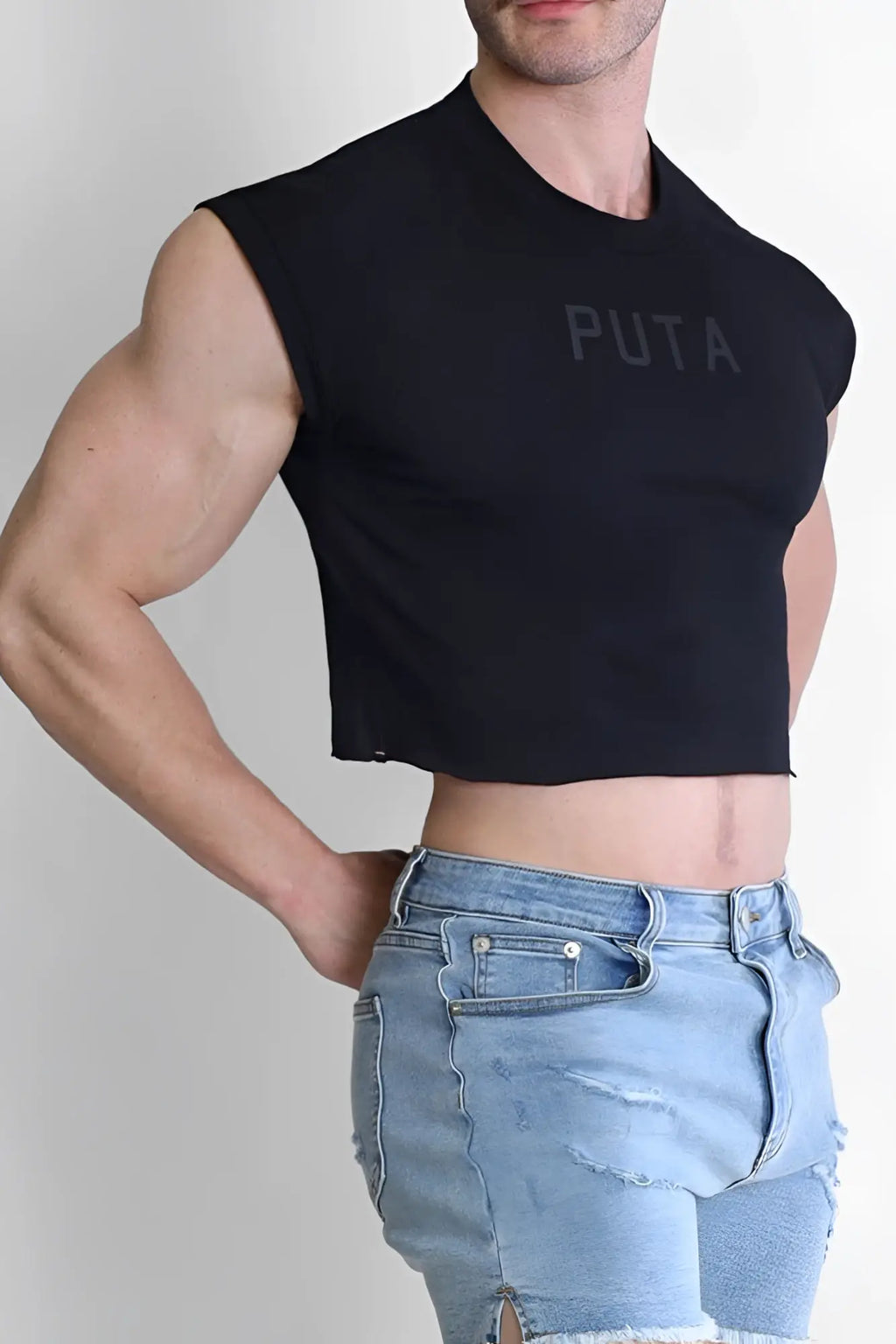 Black sleeveless muscle-fit crop tank top with puta printed in subtle gray across the chest for casual escapism style