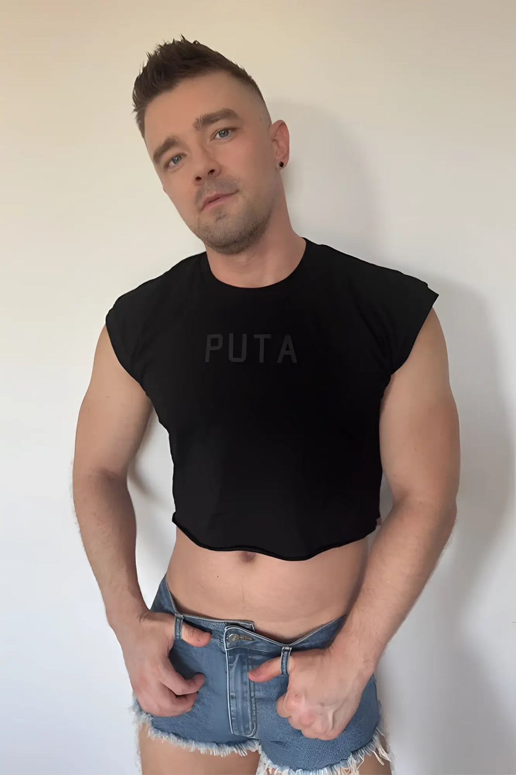 Black sleeveless muscle-fit crop tank with puta printed in dark gray across the chest for casual wear