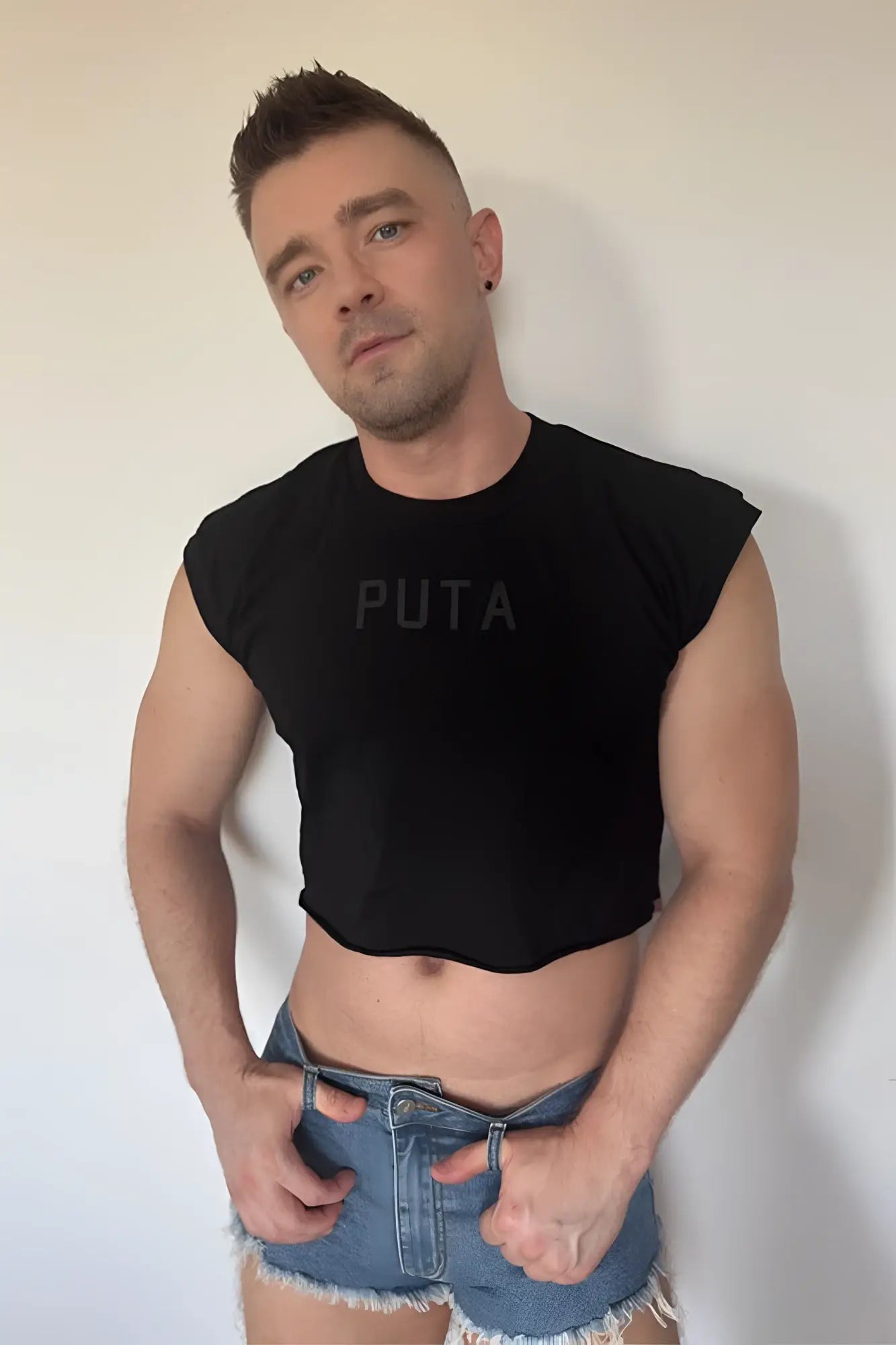 Black sleeveless muscle-fit crop tank with puta printed in dark gray across the chest for casual wear