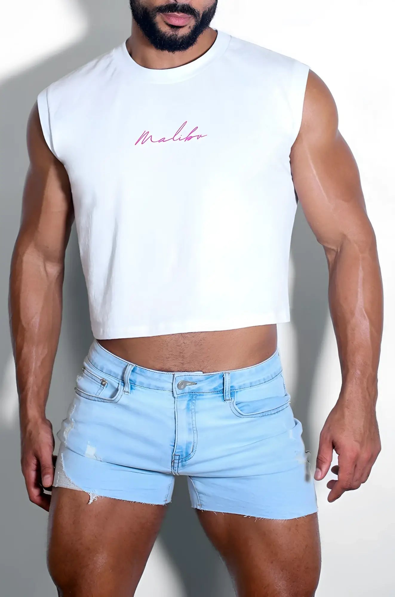 White sleeveless muscle-fit crop tank with pink malibu embroidery in cursive and purple logo detailing