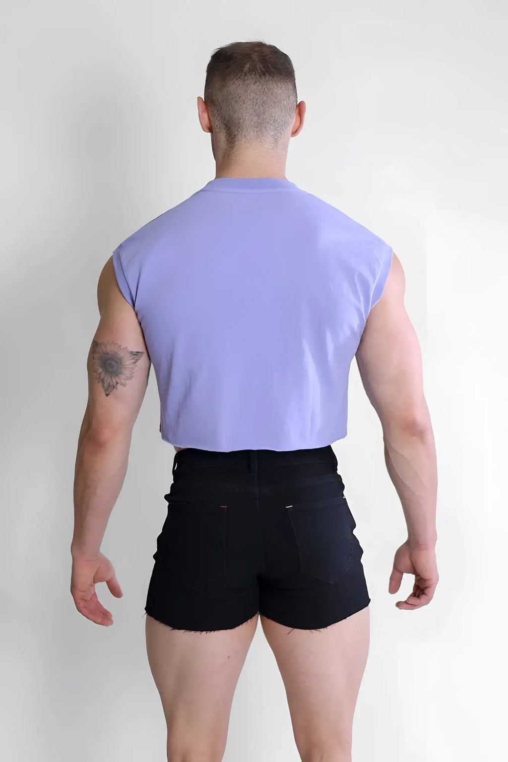 A light purple escapism muscle-fit crop tank with a sleeveless design and simple round neckline by zaddy