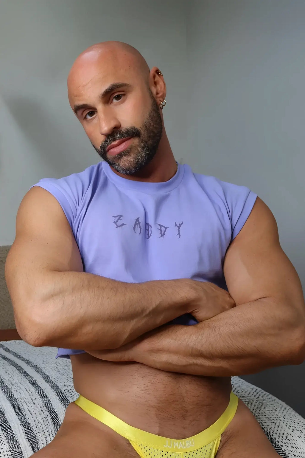 Yellow mesh briefs with jj raw branding complementing the escapism muscle-fit crop tank zaddy collection