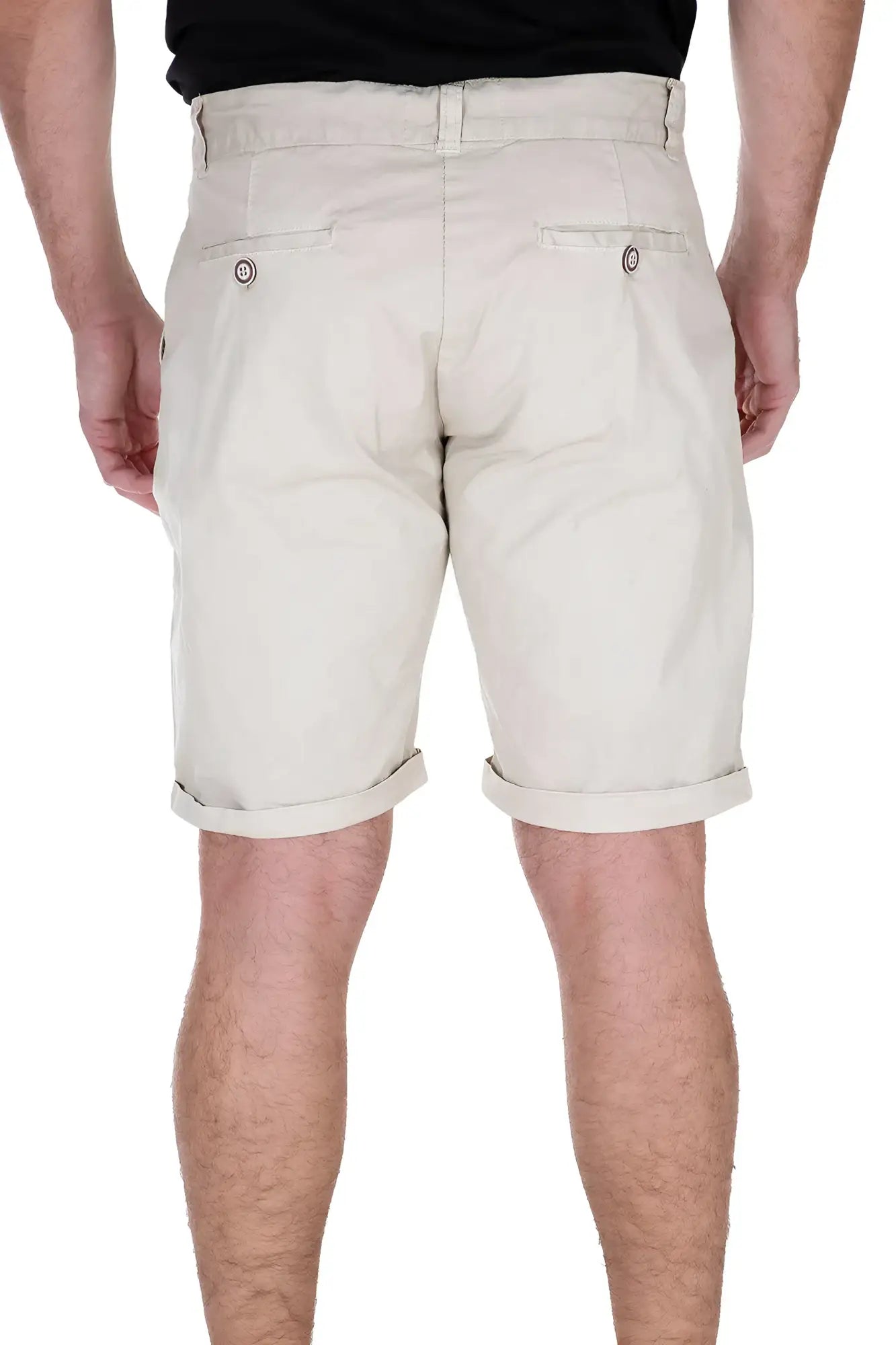 Beige essential cotton chino shorts with rolled cuffs and buttoned back pockets shown from the back side