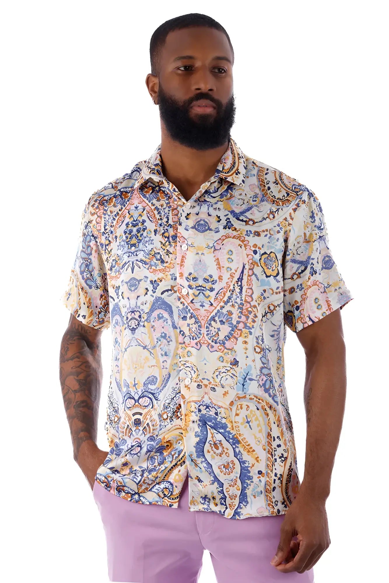 A man wearing an exclusive buzz s s shirt with a blue orange cream paisley pattern on short sleeves and light fabric