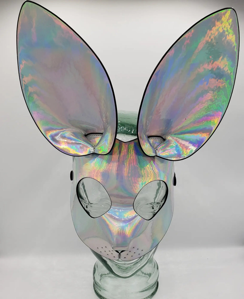 Iridescent holographic exotic bunny mask with oversized ears and reflective surface for costume or party use