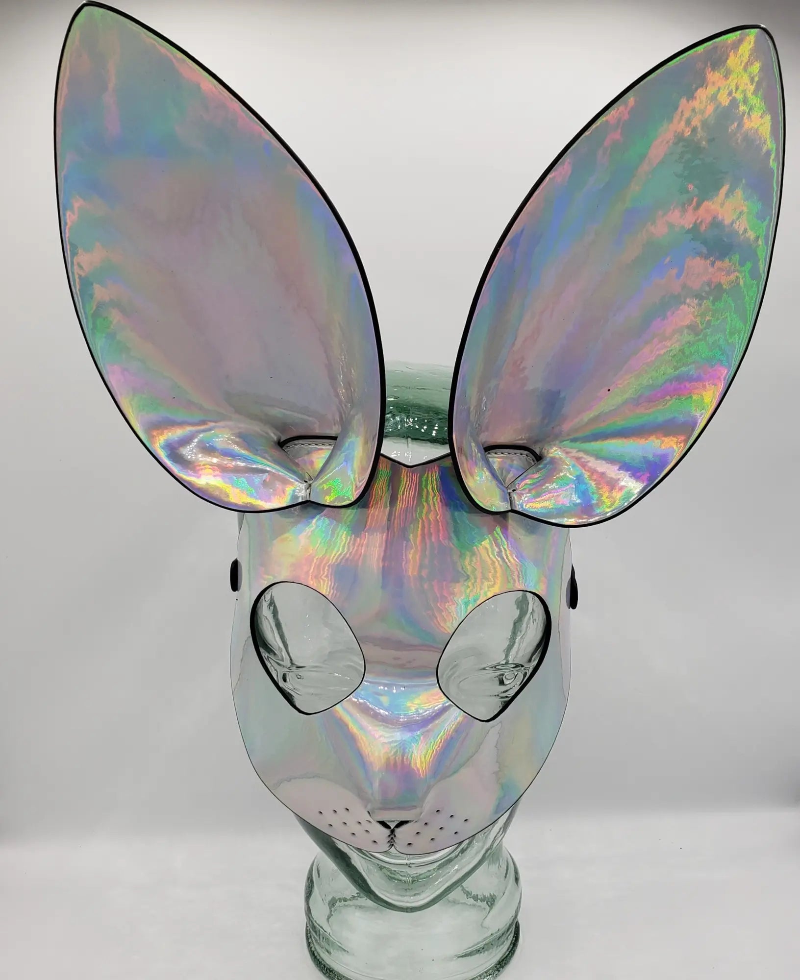 Iridescent holographic exotic bunny mask with oversized ears and reflective surface for costume or party use