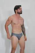 Black and white patterned fancy symbols swim brief with repeating geometric design for swimming and beachwear