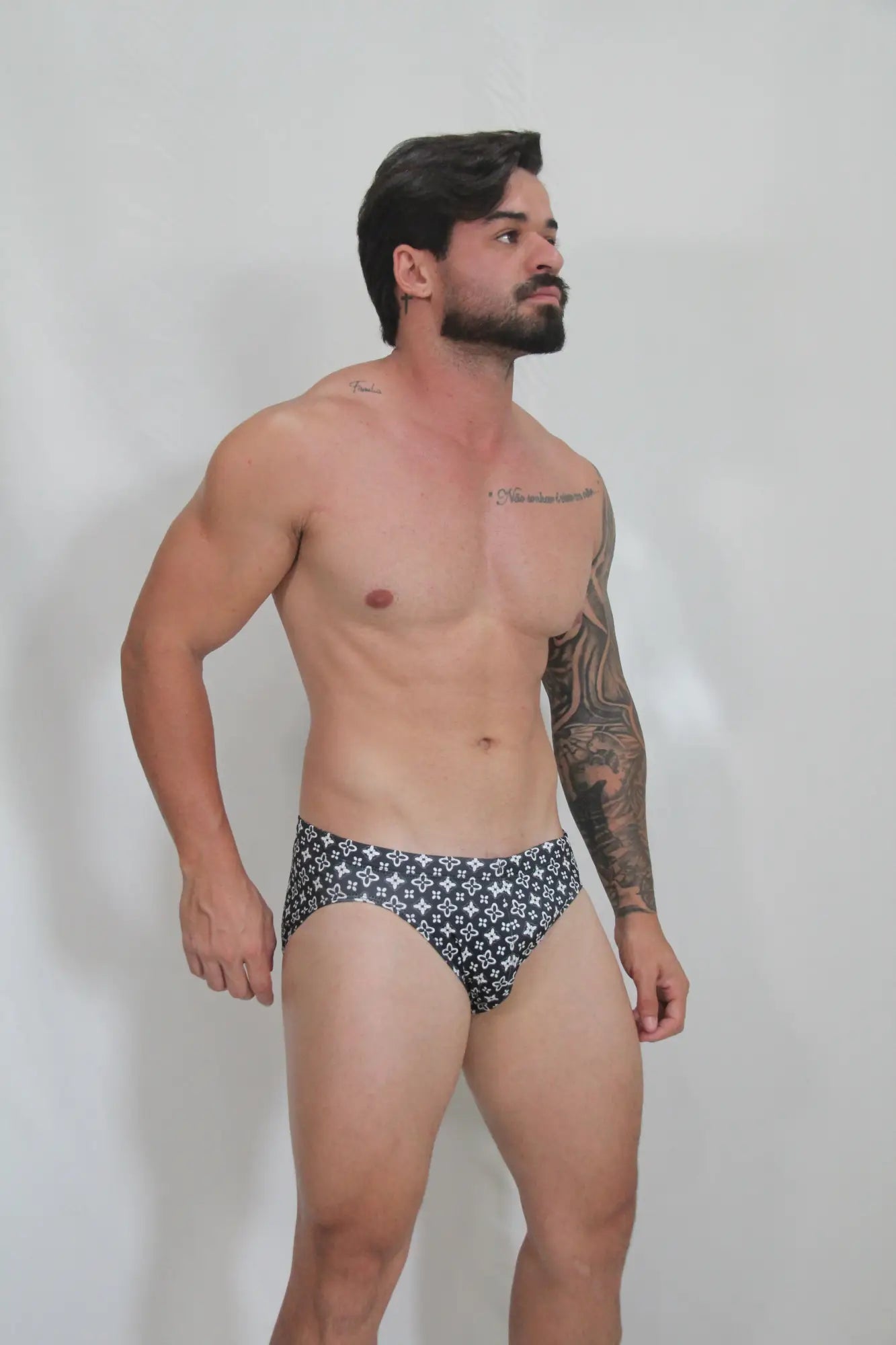 Black and white patterned fancy symbols swim brief with repeating geometric design for swimming and beachwear