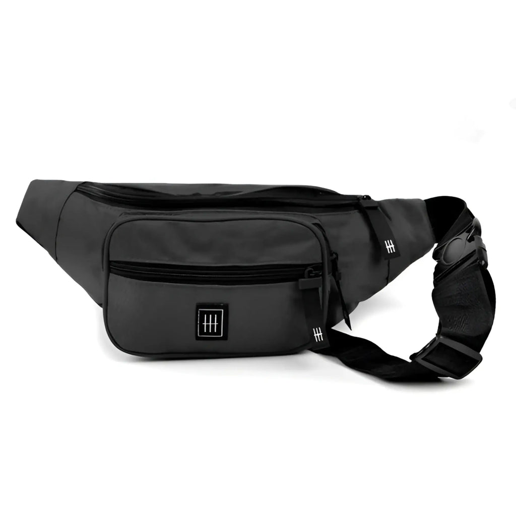 Black nylon fanny pack with multiple zippered compartments and a branded logo patch for hands-free carrying