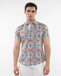 A man wearing a fauna print stretch knit short-sleeved shirt with colorful geometric pattern in blue green red and beige