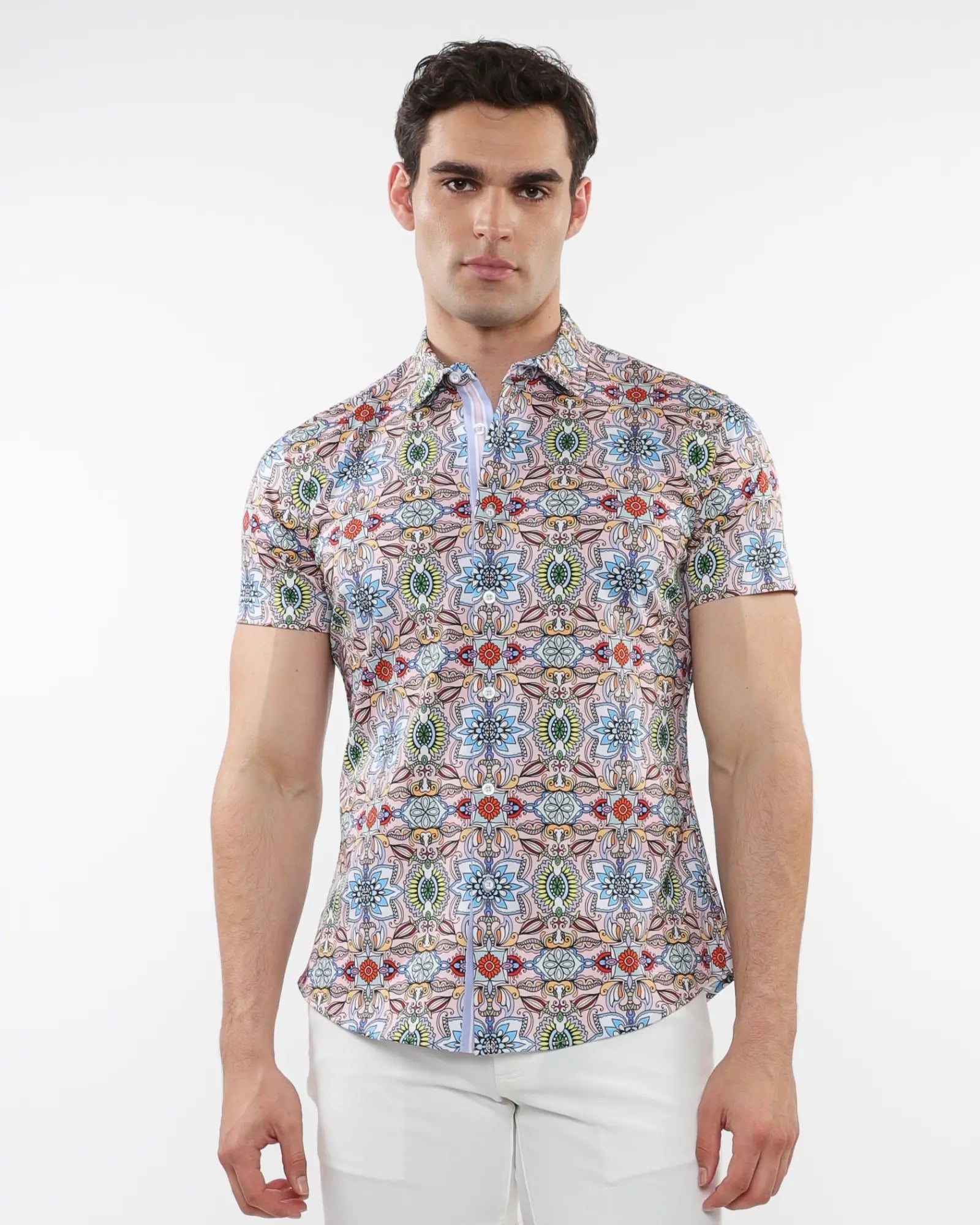 A man wearing a fauna print stretch knit short-sleeved shirt with colorful geometric pattern in blue green red and beige