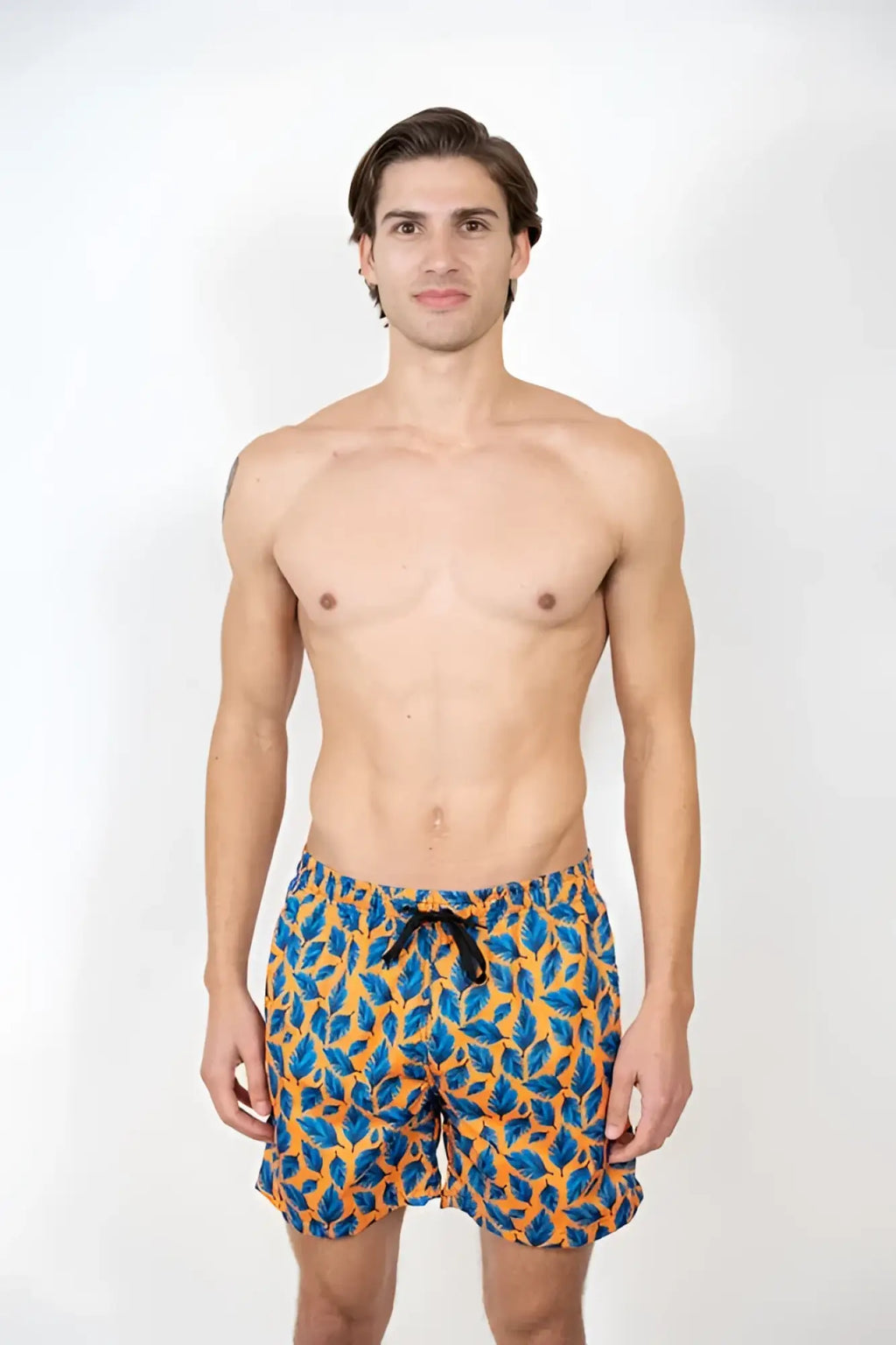 Men’s feather print swim shorts with vibrant blue and orange leaf pattern and black drawstring waistband