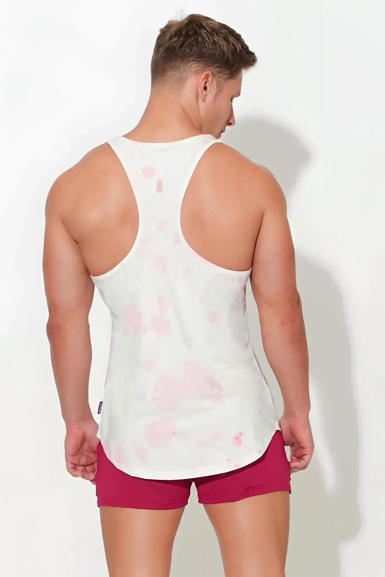White tank top with pink tie-dye pattern featuring a scoop bottom for casual comfort and stylish wear