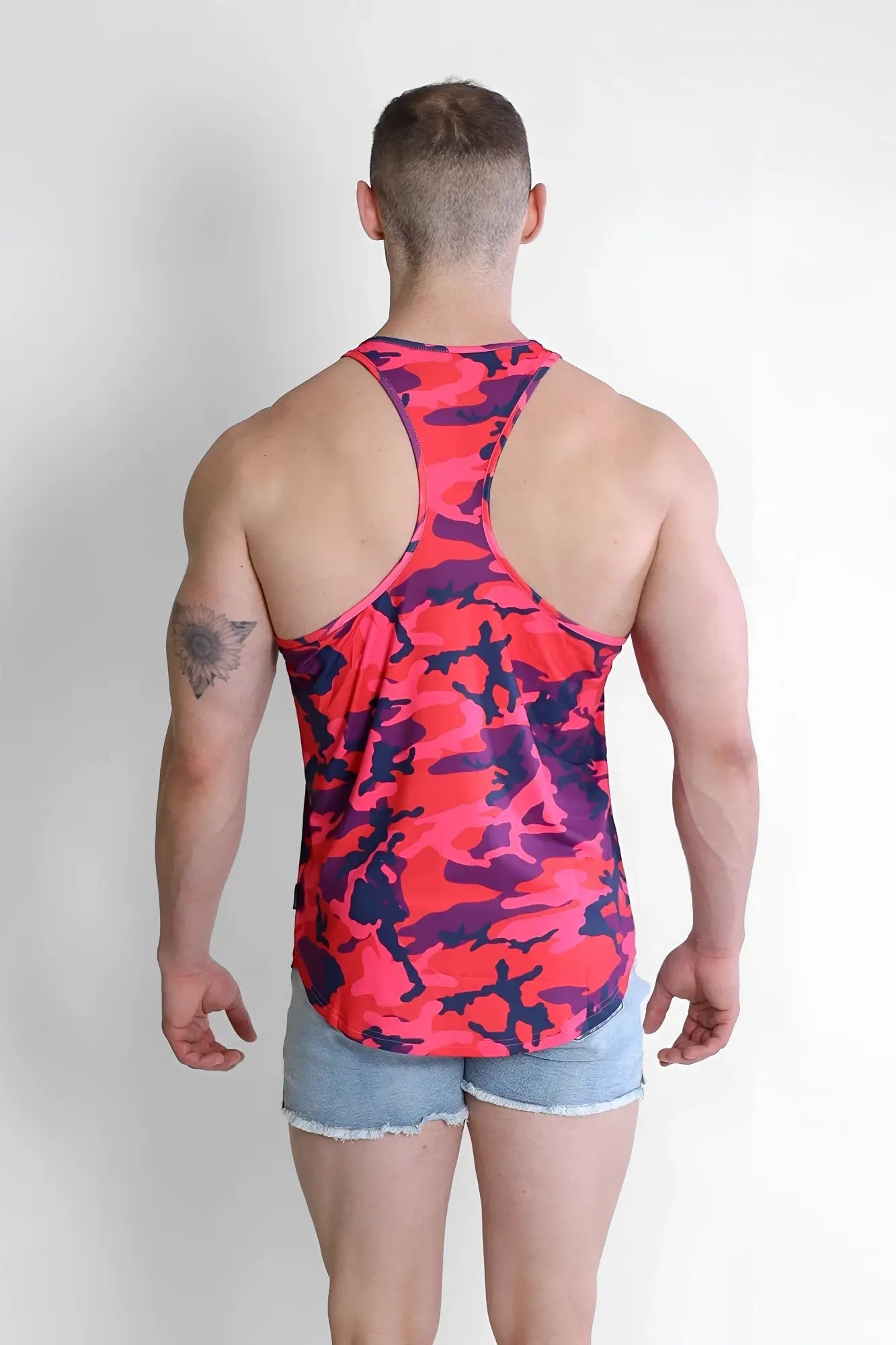 A vibrant pink and purple camouflage racerback tank top with scoop bottom from feel-me purple camo collection
