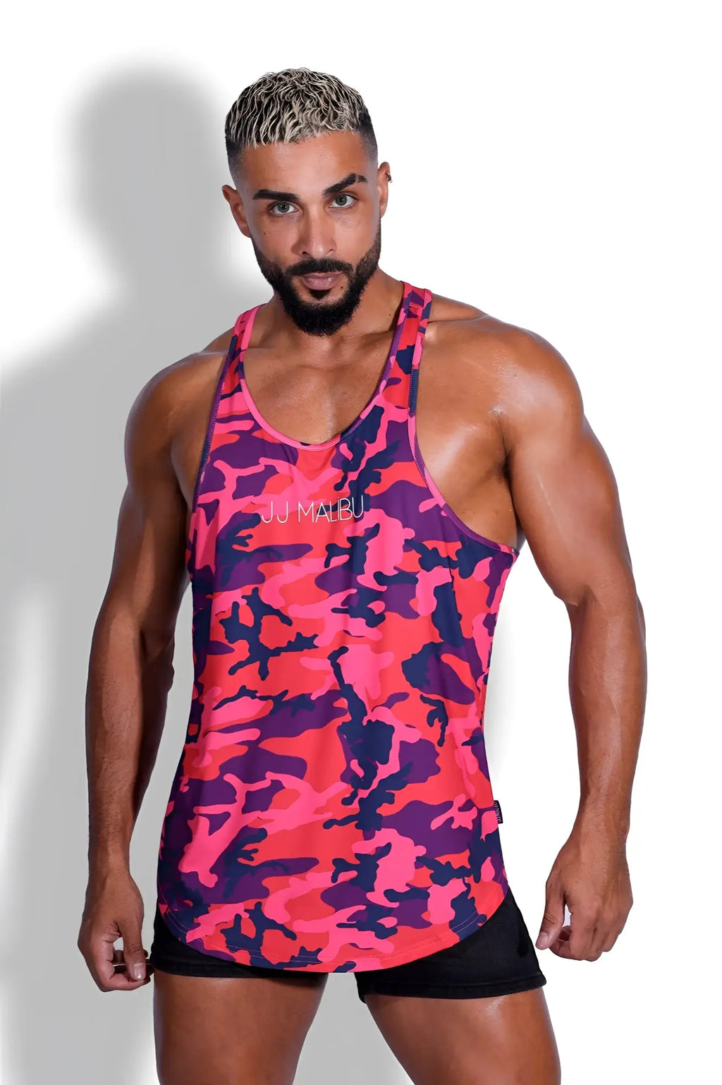 Vibrant pink and purple camouflage patterned athletic scoop bottom tank top designed for activewear and comfort