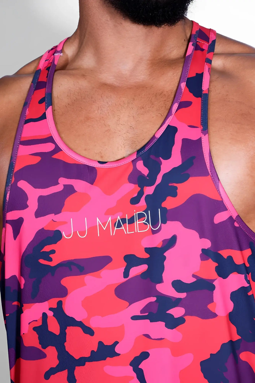 Feel-me scoop bottom tank in vibrant pink and purple camo with white jj malibu logo across the chest