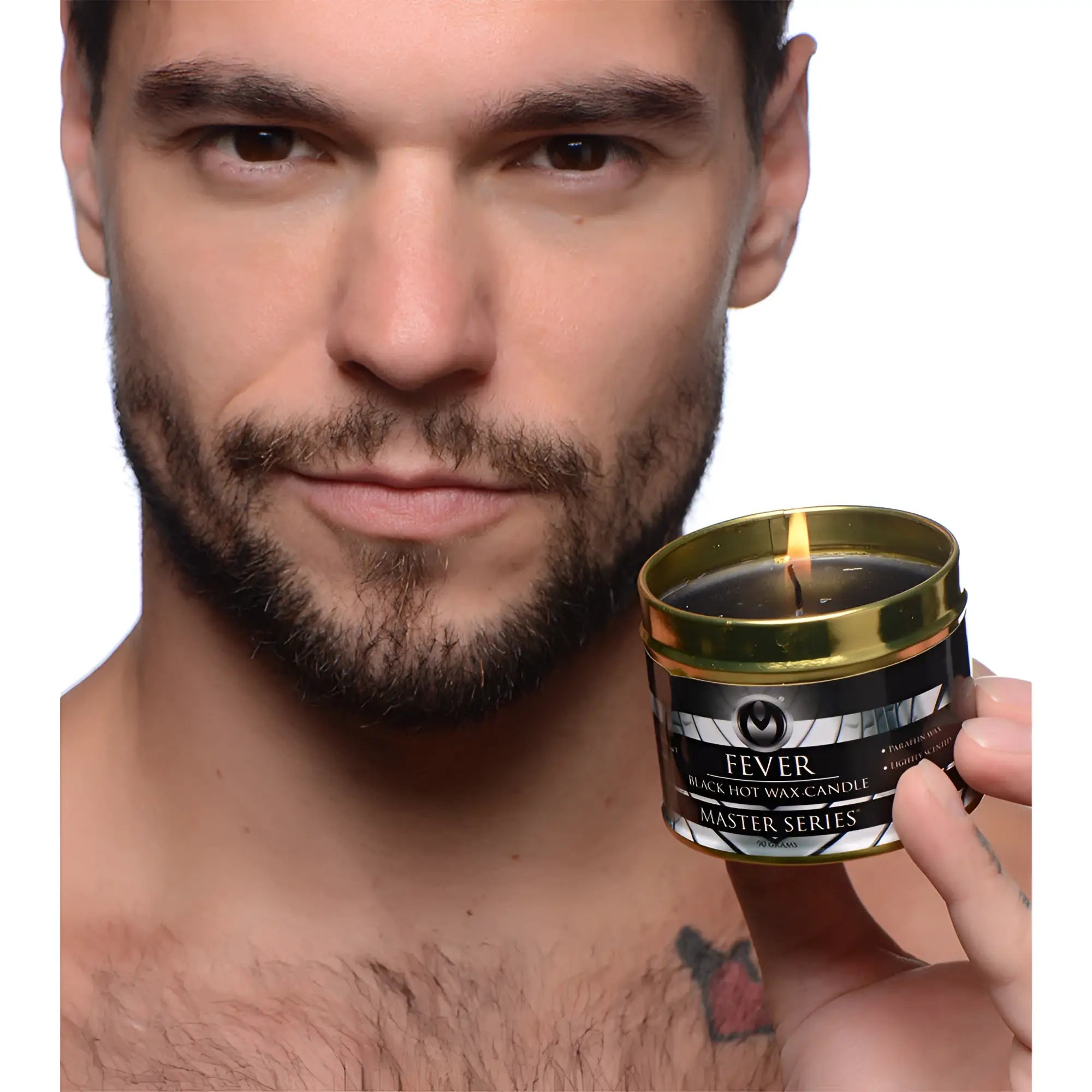 Gold-rimmed tin holding a black hot wax candle with lit wick labeled fever from the master series