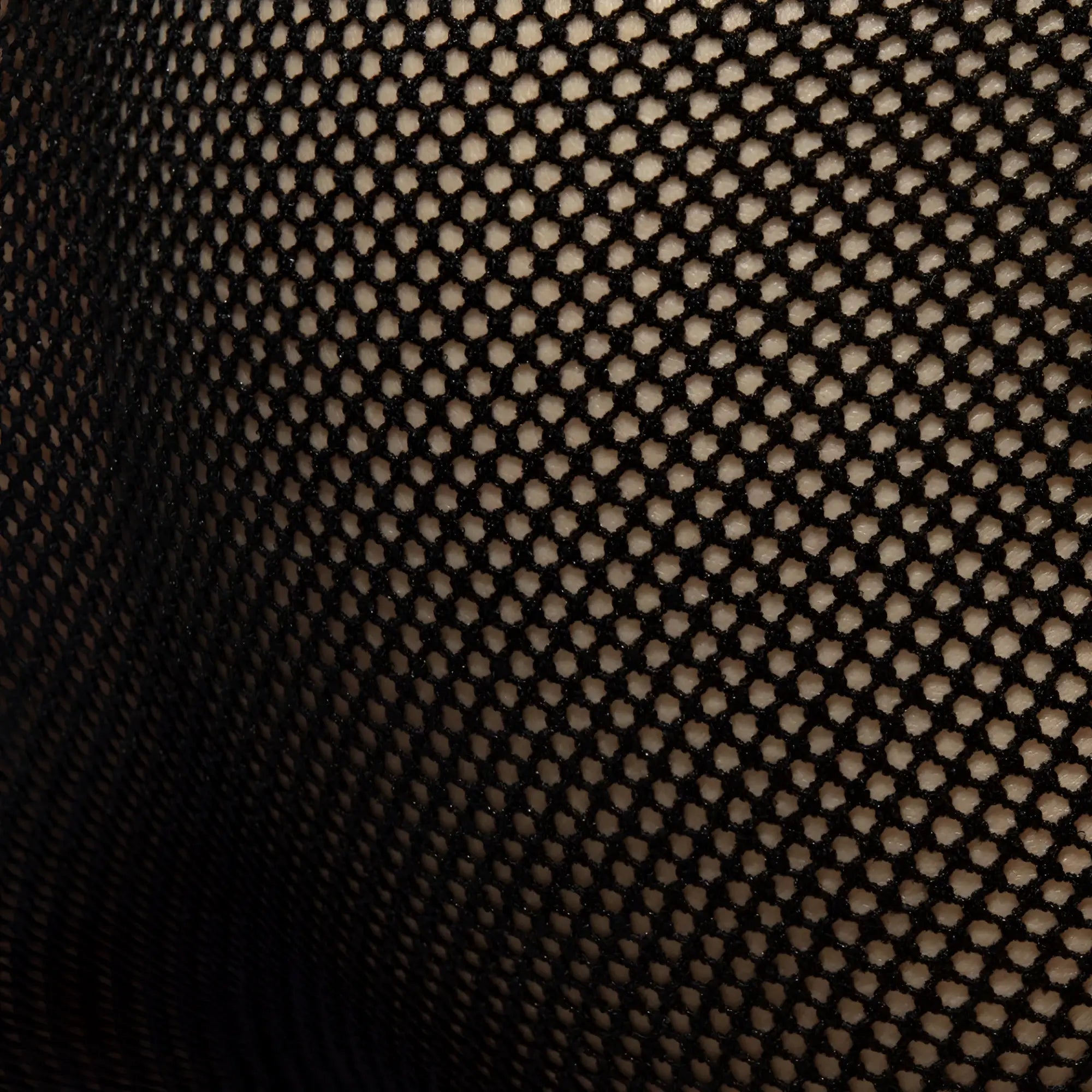 Black mesh brief featuring a consistent hexagonal pattern made from breathable mesh fabric for lightweight comfort