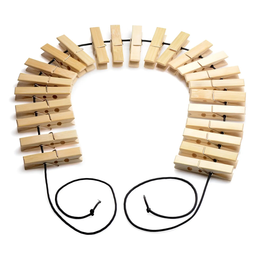 A firecracker clothespin body zipper necklace made of light-colored wooden clothespins strung on a black cord