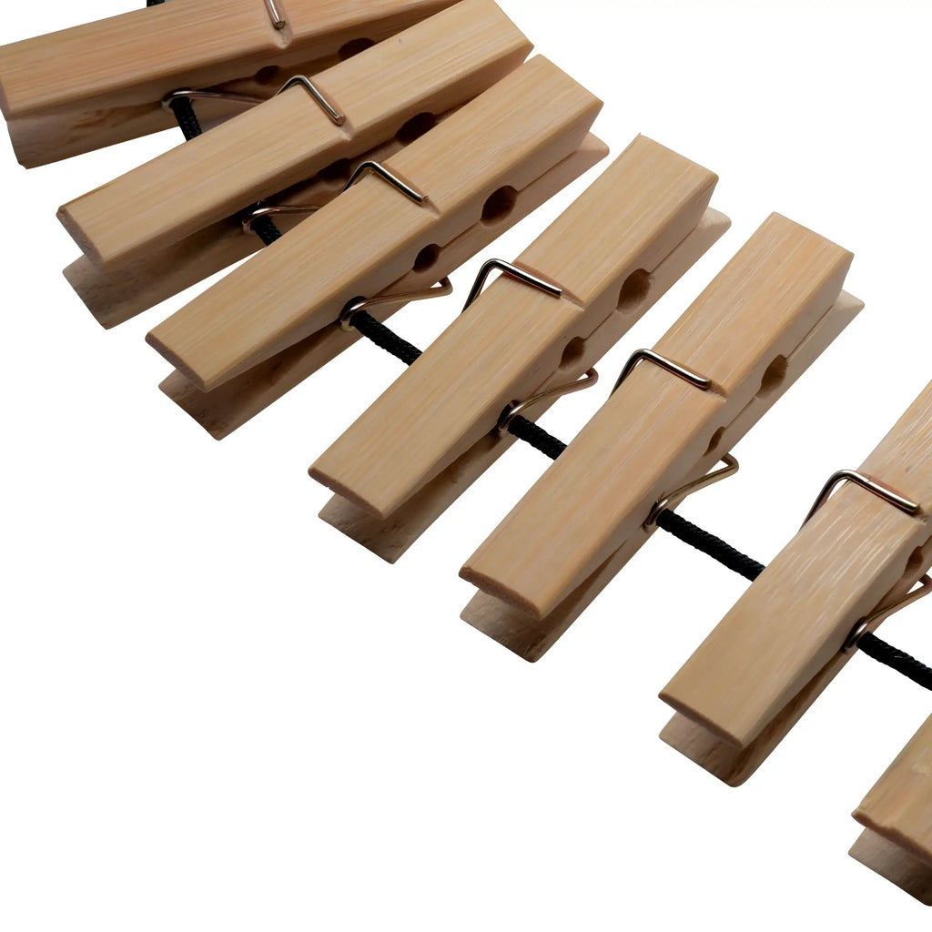 Light-colored wooden firecracker clothespin body zipper with metal springs and black string for secure fastening
