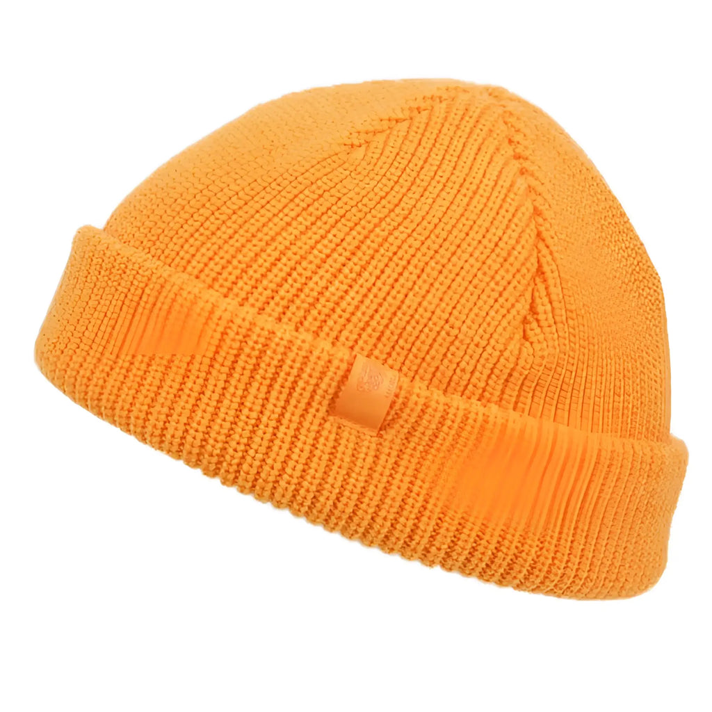 A vibrant orange fisherman dock knit cuff beanie in ribbed knit with a folded cuff and small fabric tag on the side
