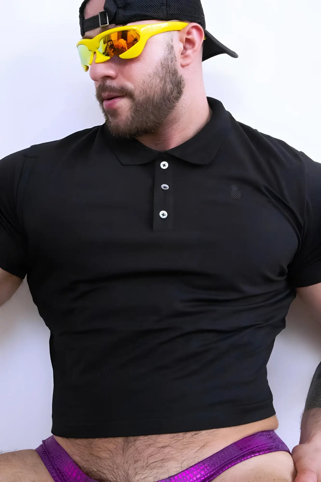 Black fitted polo crop top with short sleeves white buttons and subtle chest logo perfect for casual wear