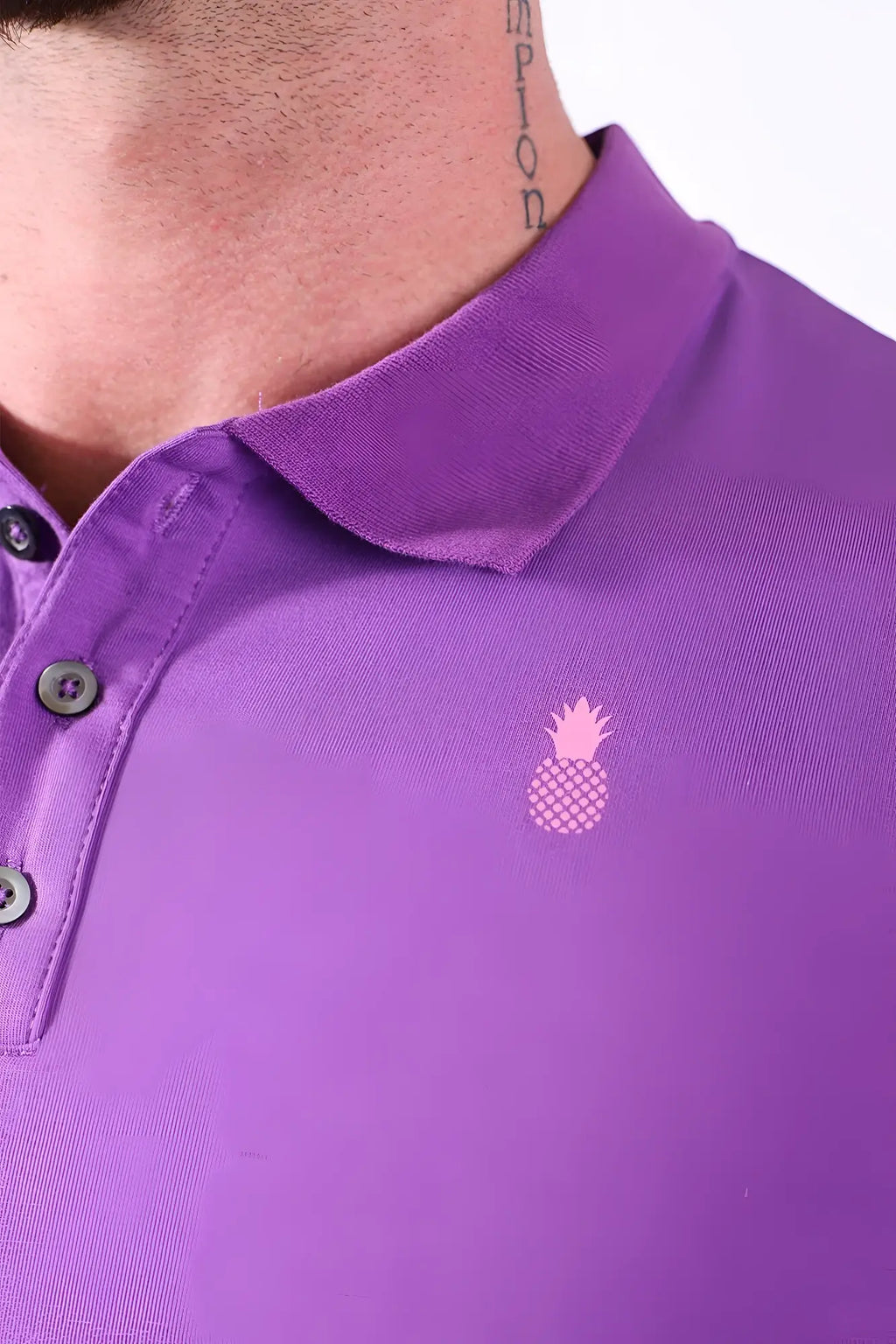 Fitted polo crop top in purple with a pink pineapple logo and dark buttons on the chest