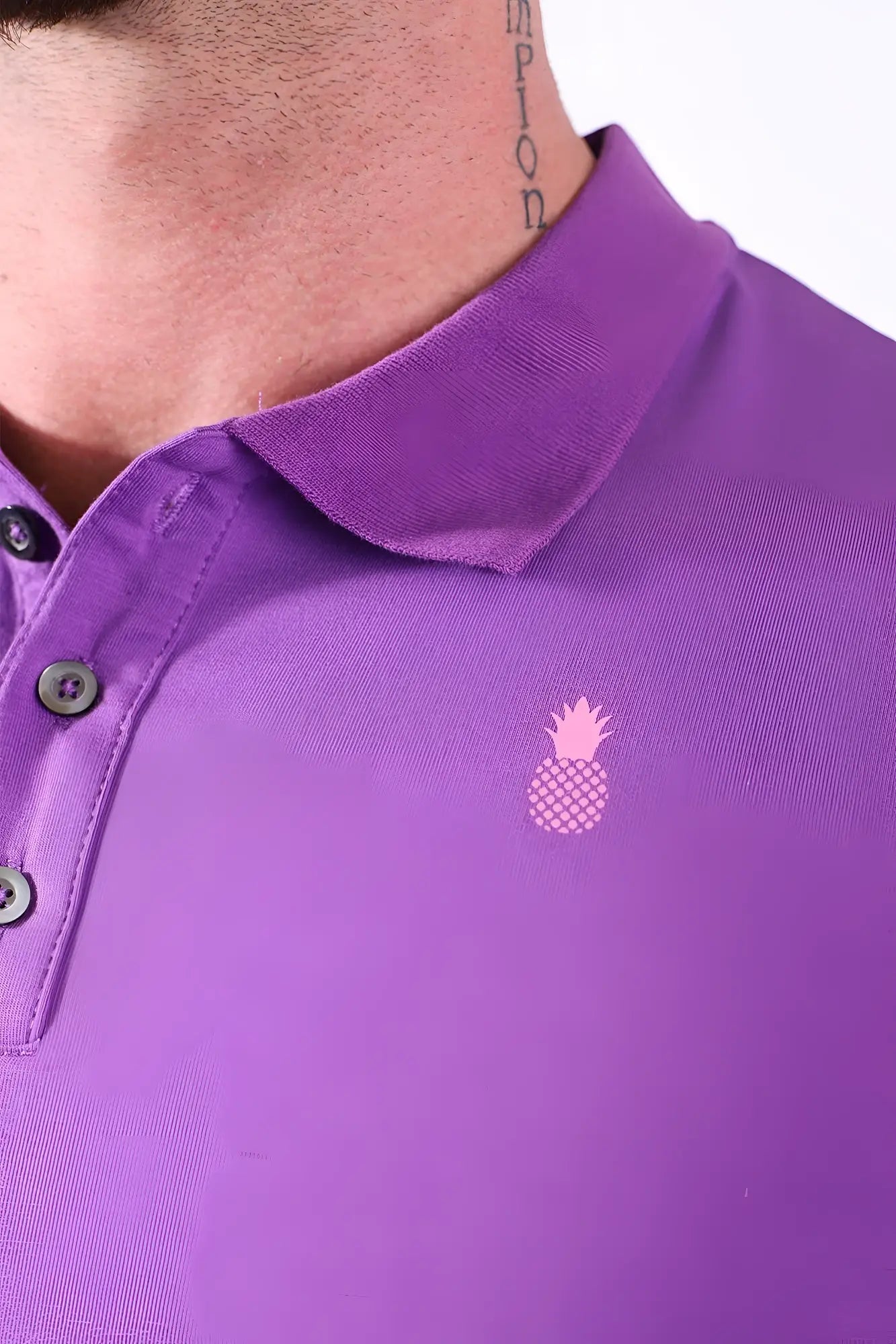 Fitted polo crop top in purple with a pink pineapple logo and dark buttons on the chest