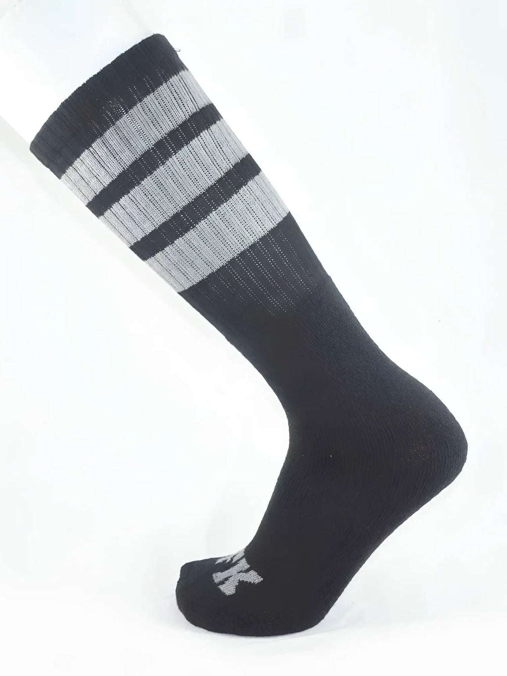 Fk sport black tube sock with ribbed texture and three horizontal stripes at the top cuff