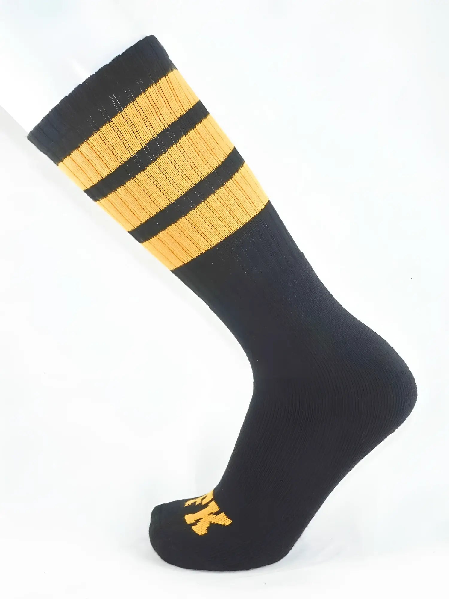 Fk sport black tube sock featuring three gold stripes near the top and a small gold logo on the toe