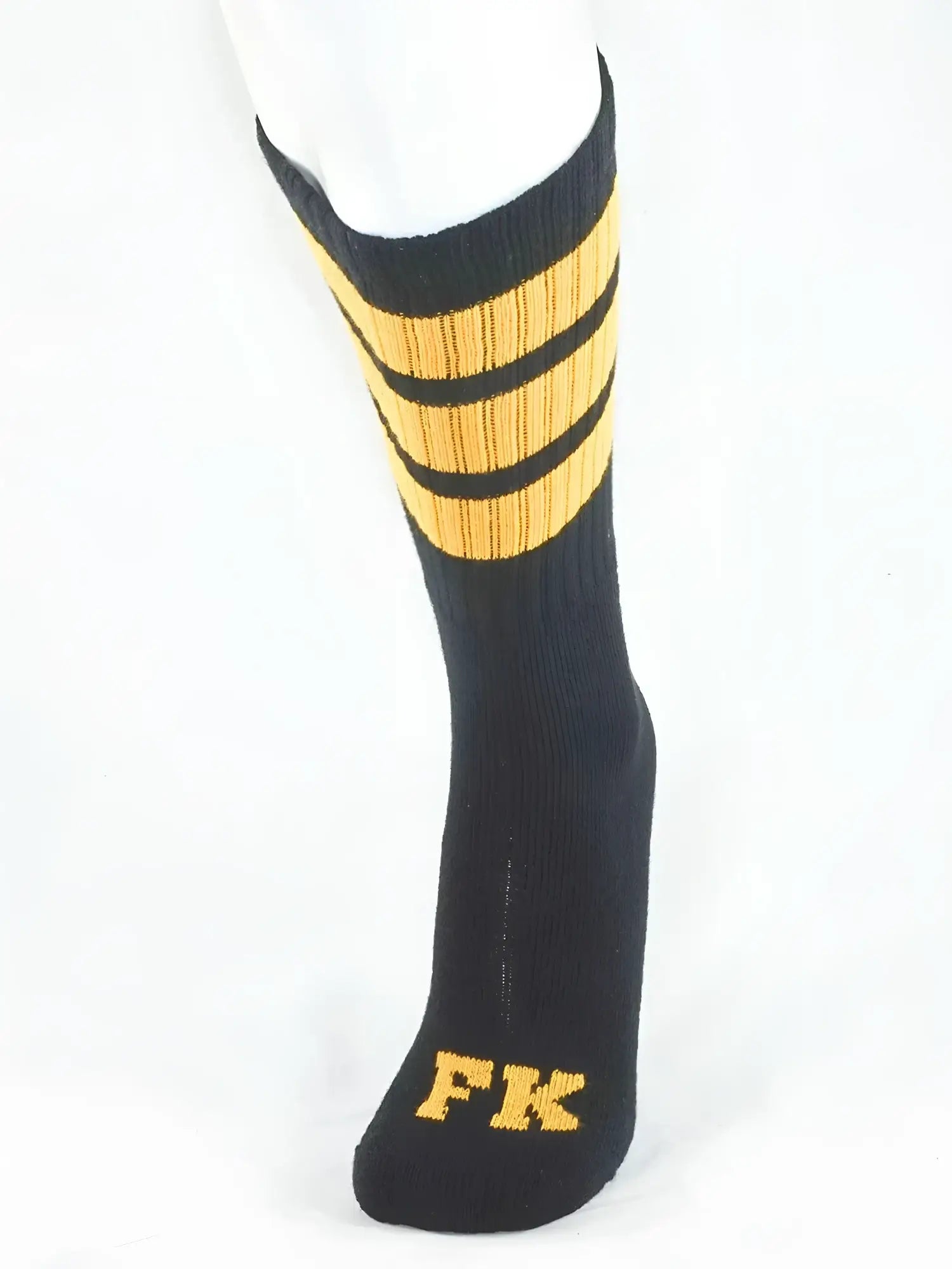Fk Sport black tube sock with three gold stripes and fk embroidery on the toe for athletic use