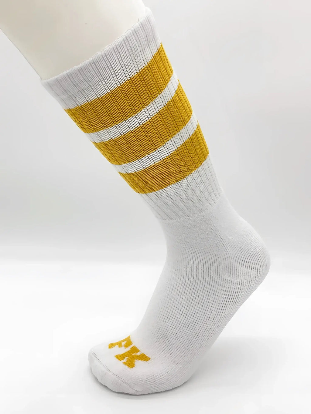 White athletic tube sock by fk sport with three mustard-yellow stripes and a small yellow logo on the toe