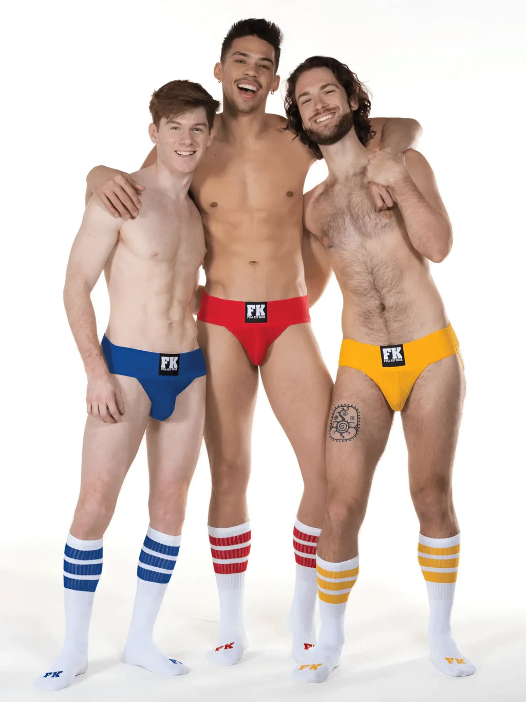 Three men wearing brightly colored low-rise briefs with black fk logo and fk sport white tube socks with stripes