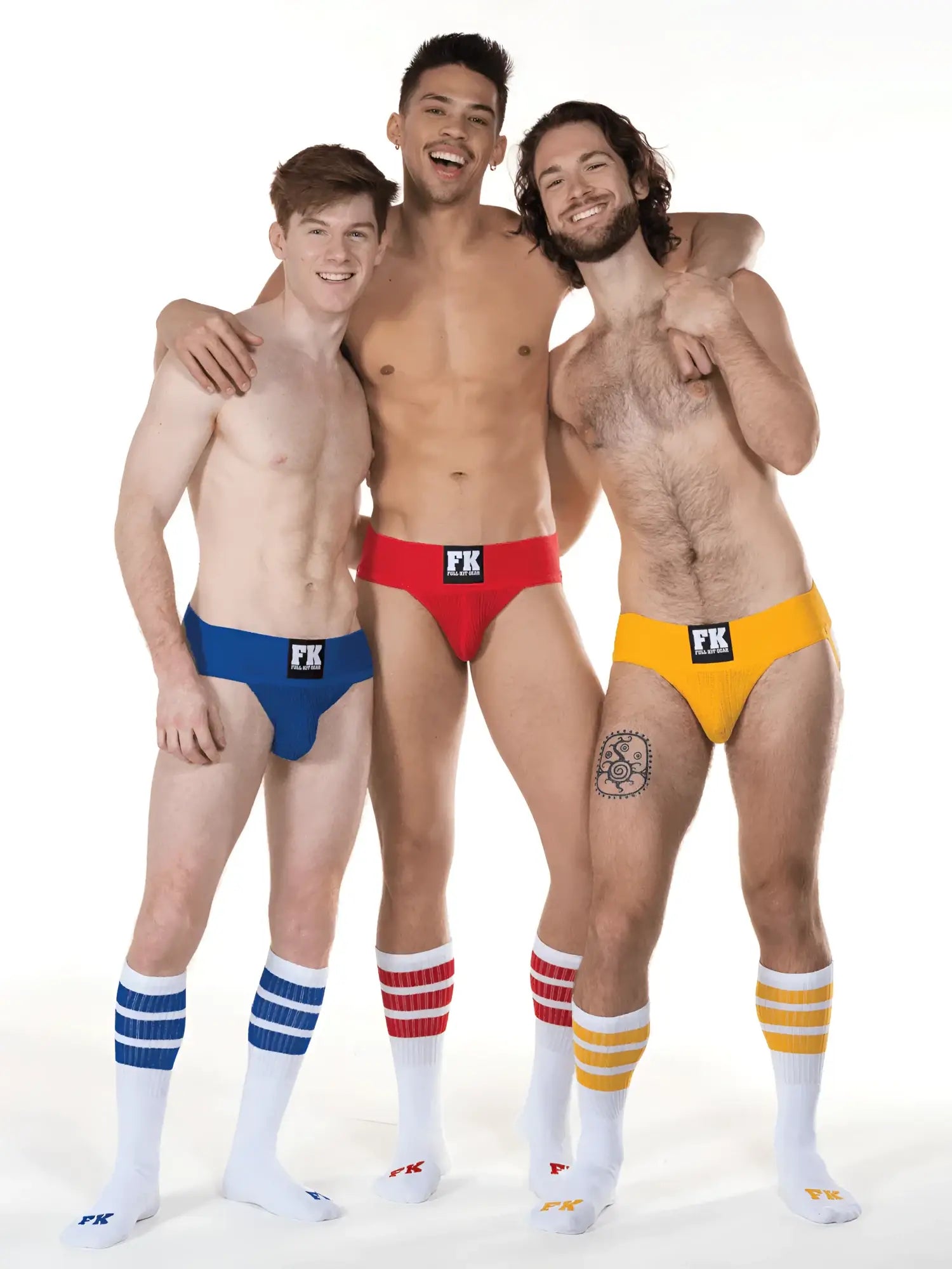 Three men wearing brightly colored low-rise briefs with black fk logo and fk sport white tube socks with stripes
