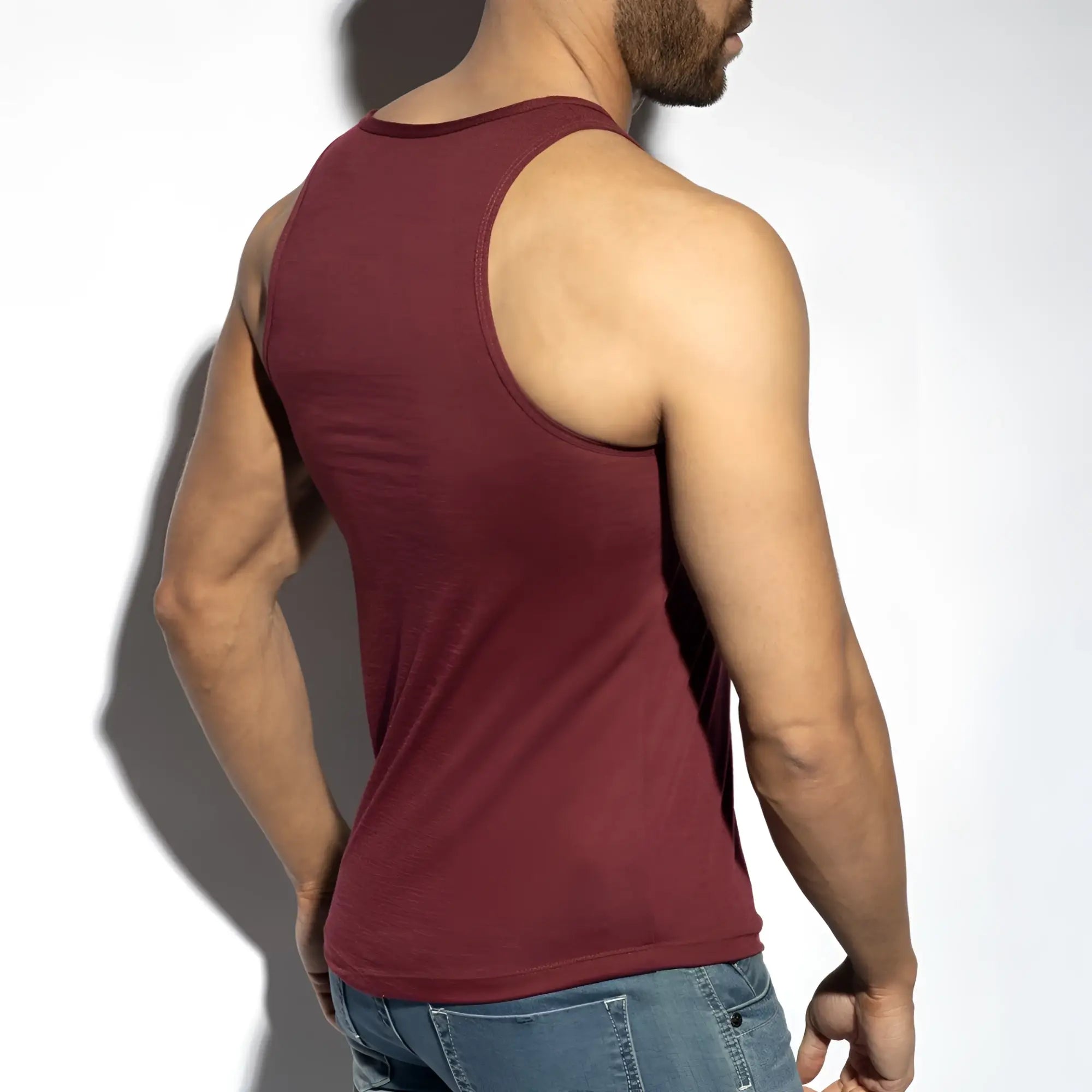 A maroon sleeveless flame tank top with a round neckline and ribbed hem for casual wear