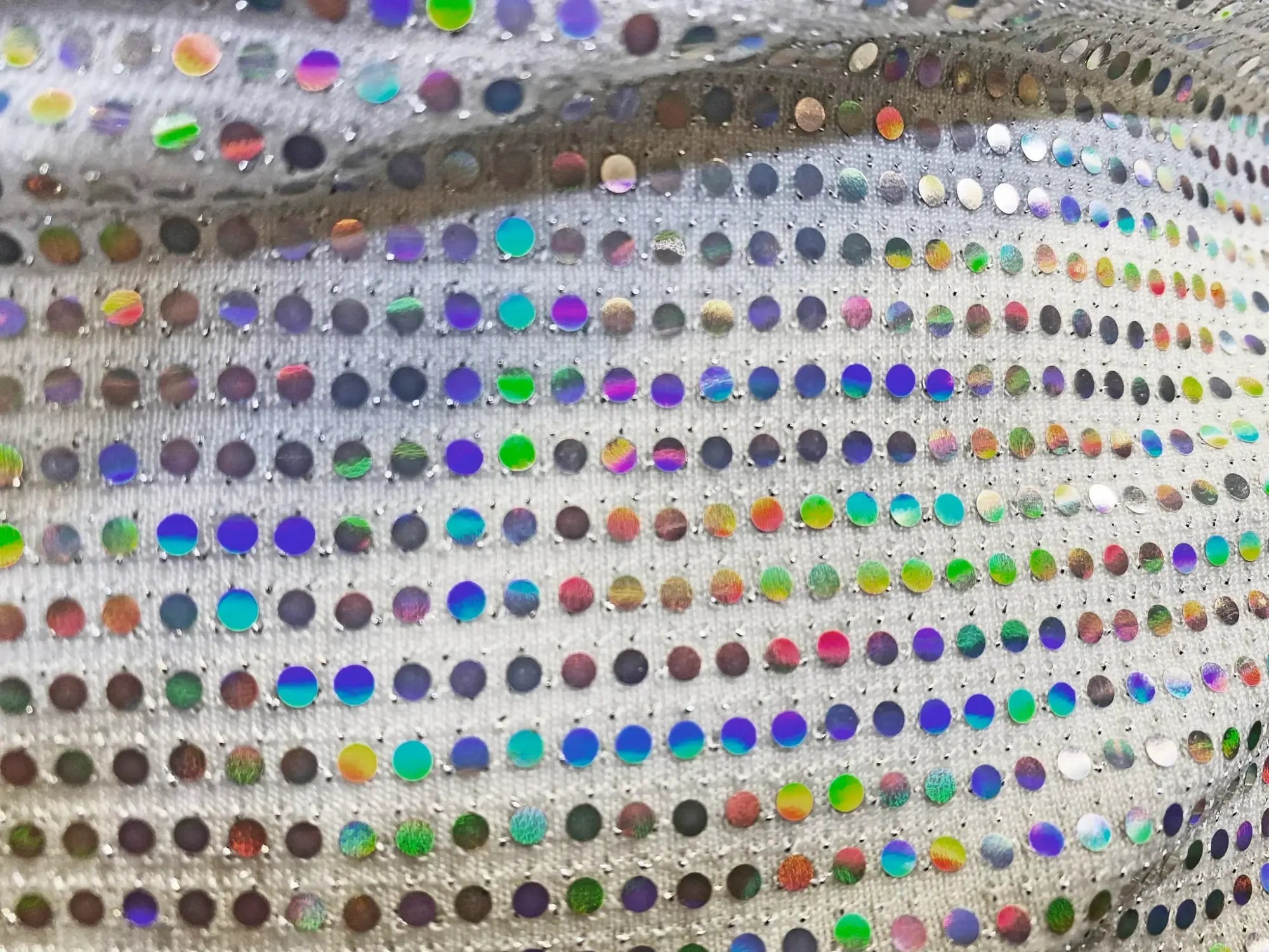 Flat sequin hooded crop top with shimmering silver fabric and multicolored iridescent sequins in a grid pattern