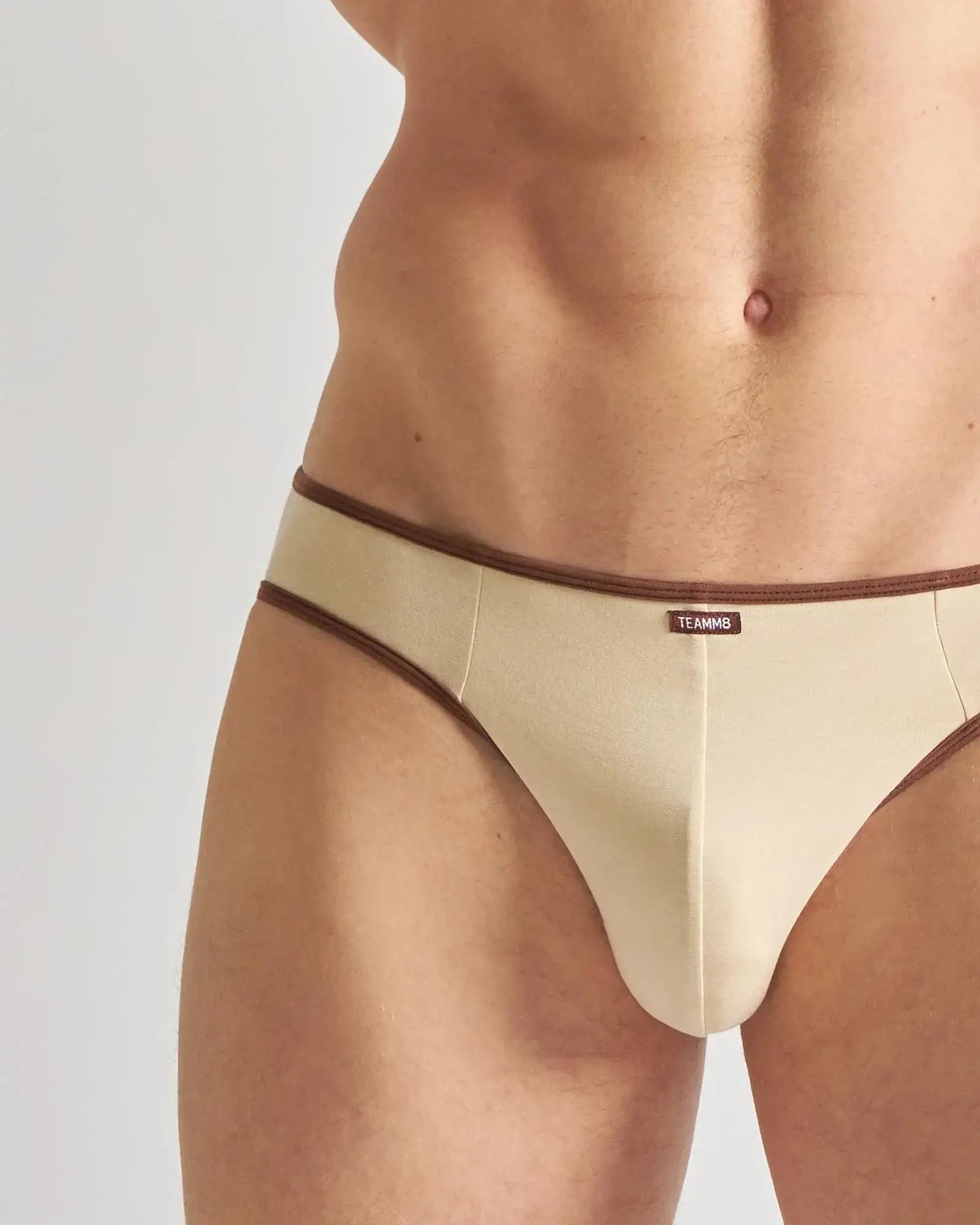 Beige teammg briefs jockstrap with brown trim designed for comfortable athletic support and style