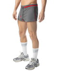 Gray flex trunk shorts with red trim and drawstring waistband designed for athletic use