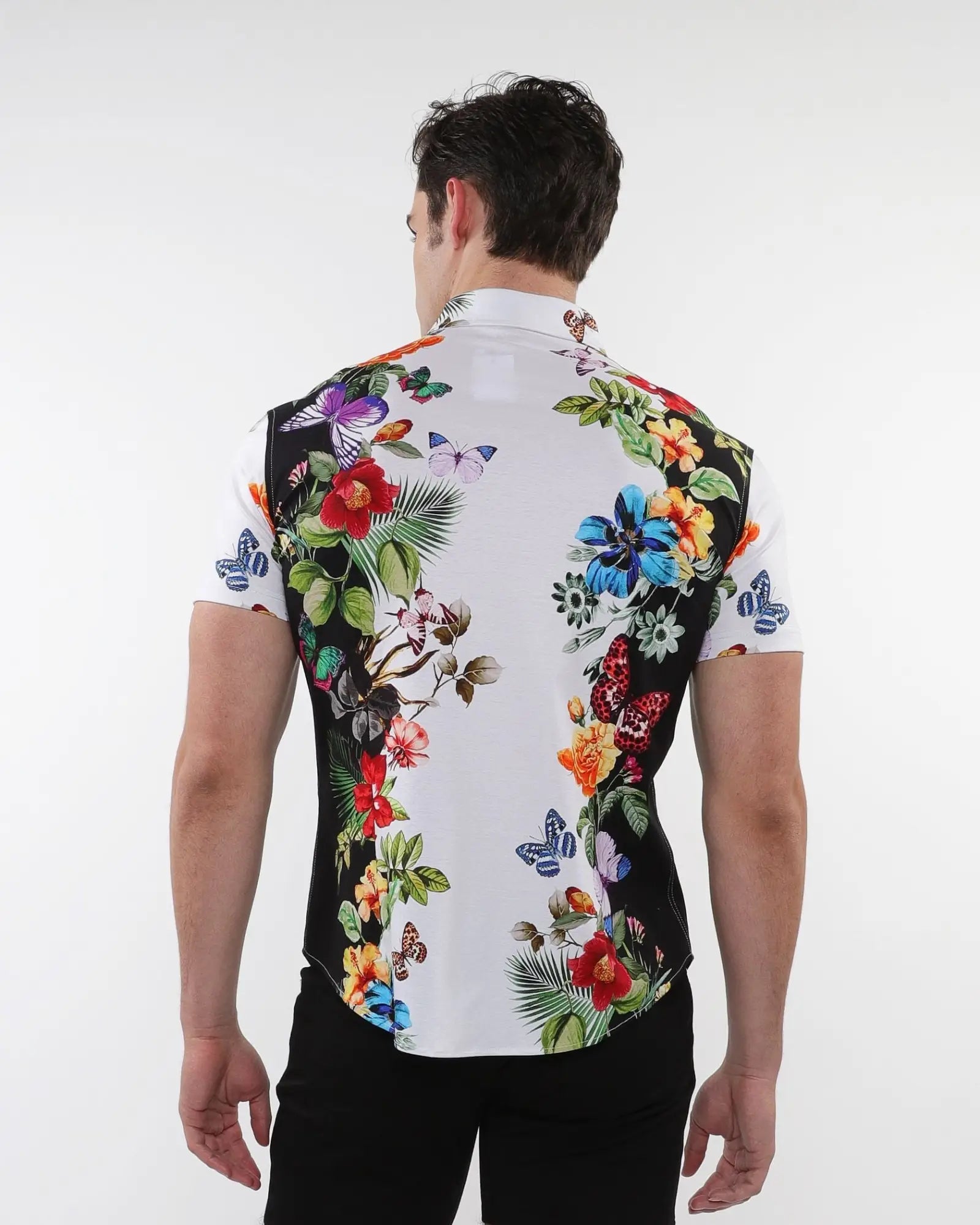 Floral border print stretch knit shirt featuring a vibrant red blue purple and green floral butterfly design on white
